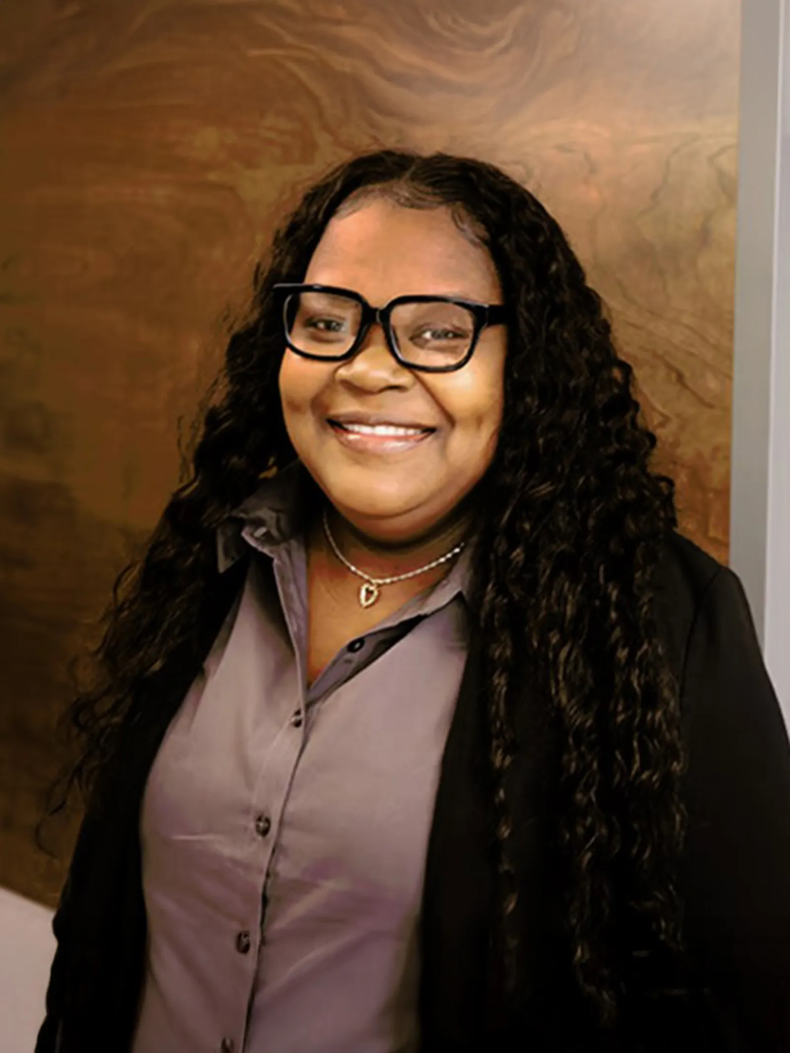 a woman with long curly hair wearing glasses