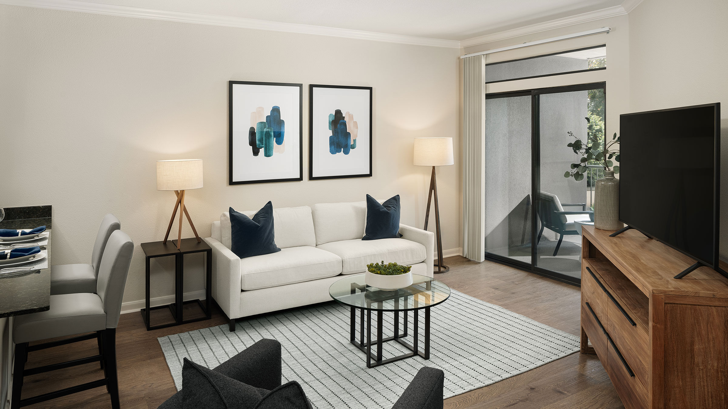 a living room with a white couch and a glass table