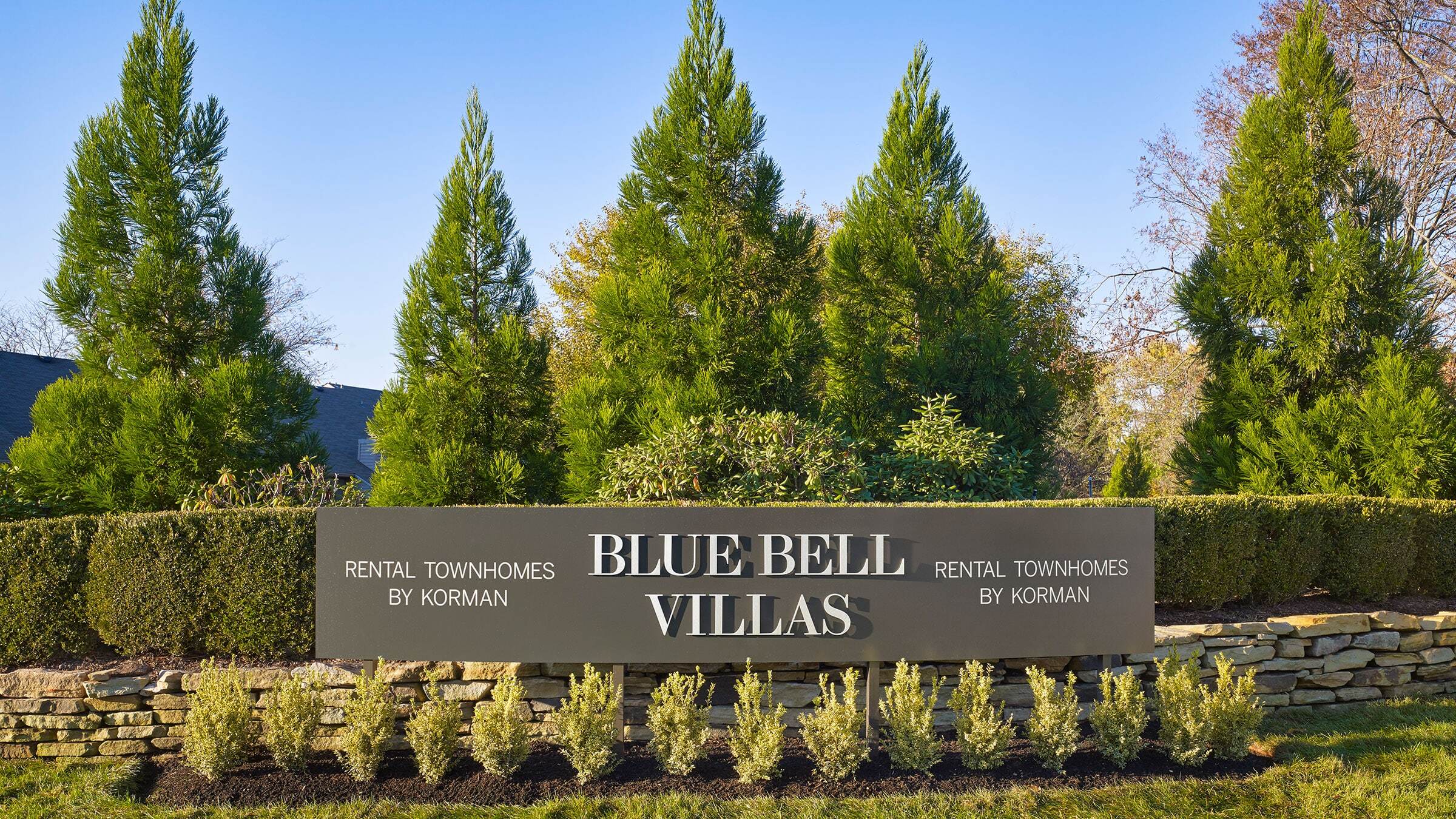 a sign with trees in the background