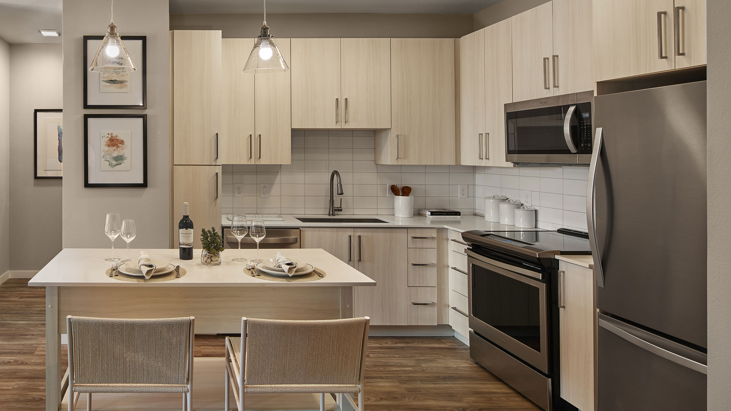 a kitchen with white cabinets and a table
