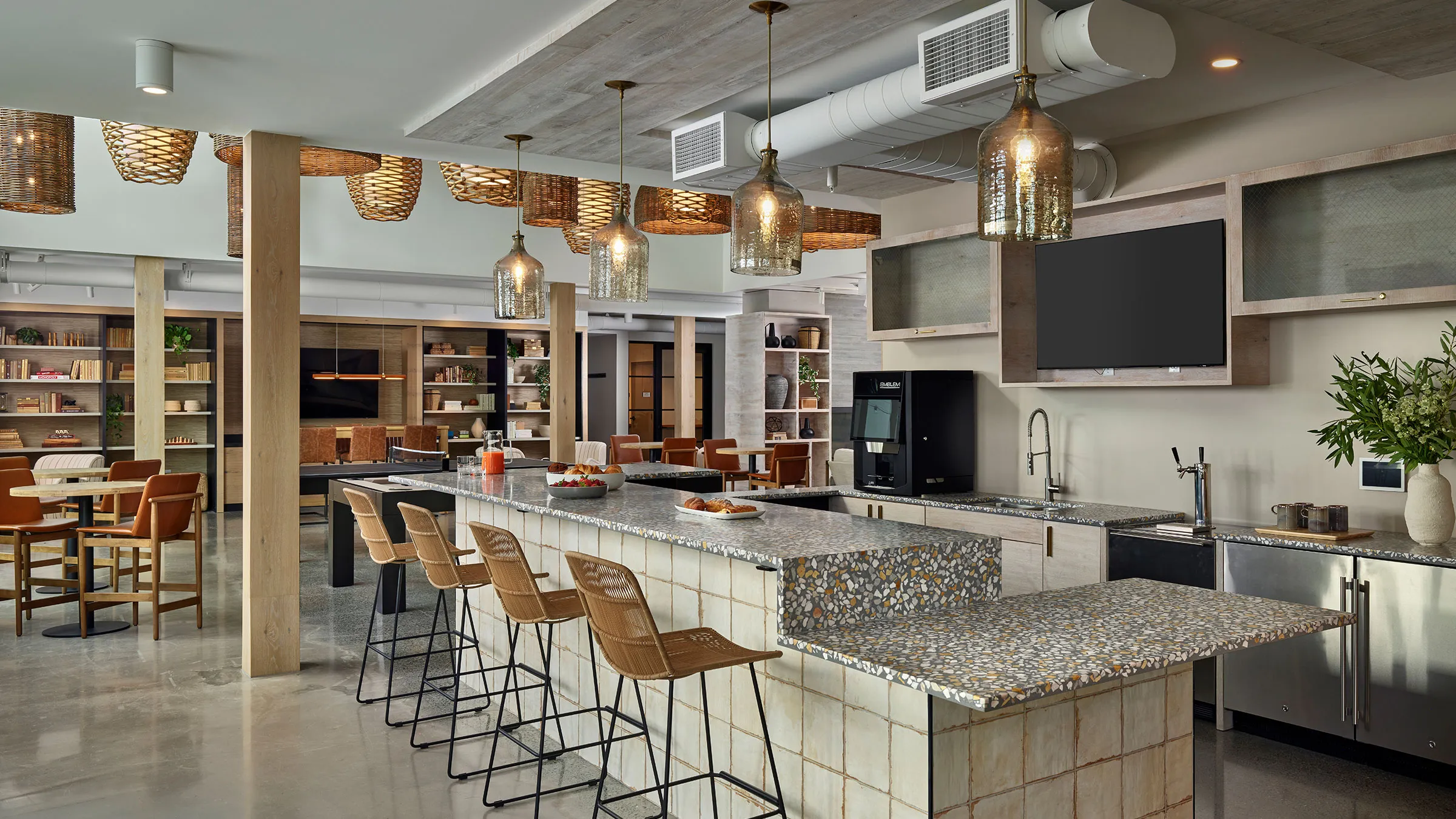 a kitchen with a bar and chairs