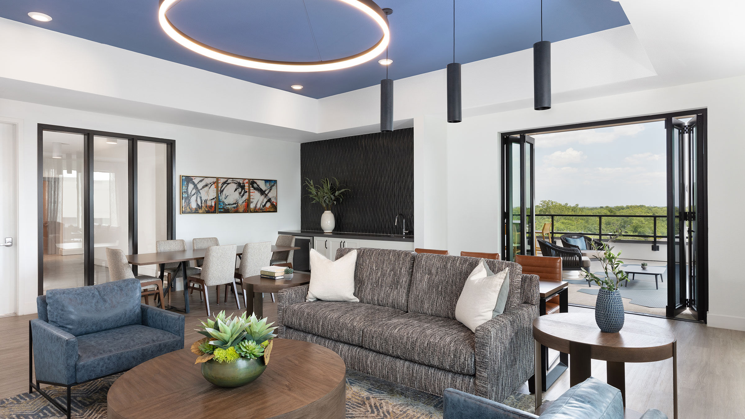 resident lounge at AVE Austin apartments with a couch and chairs