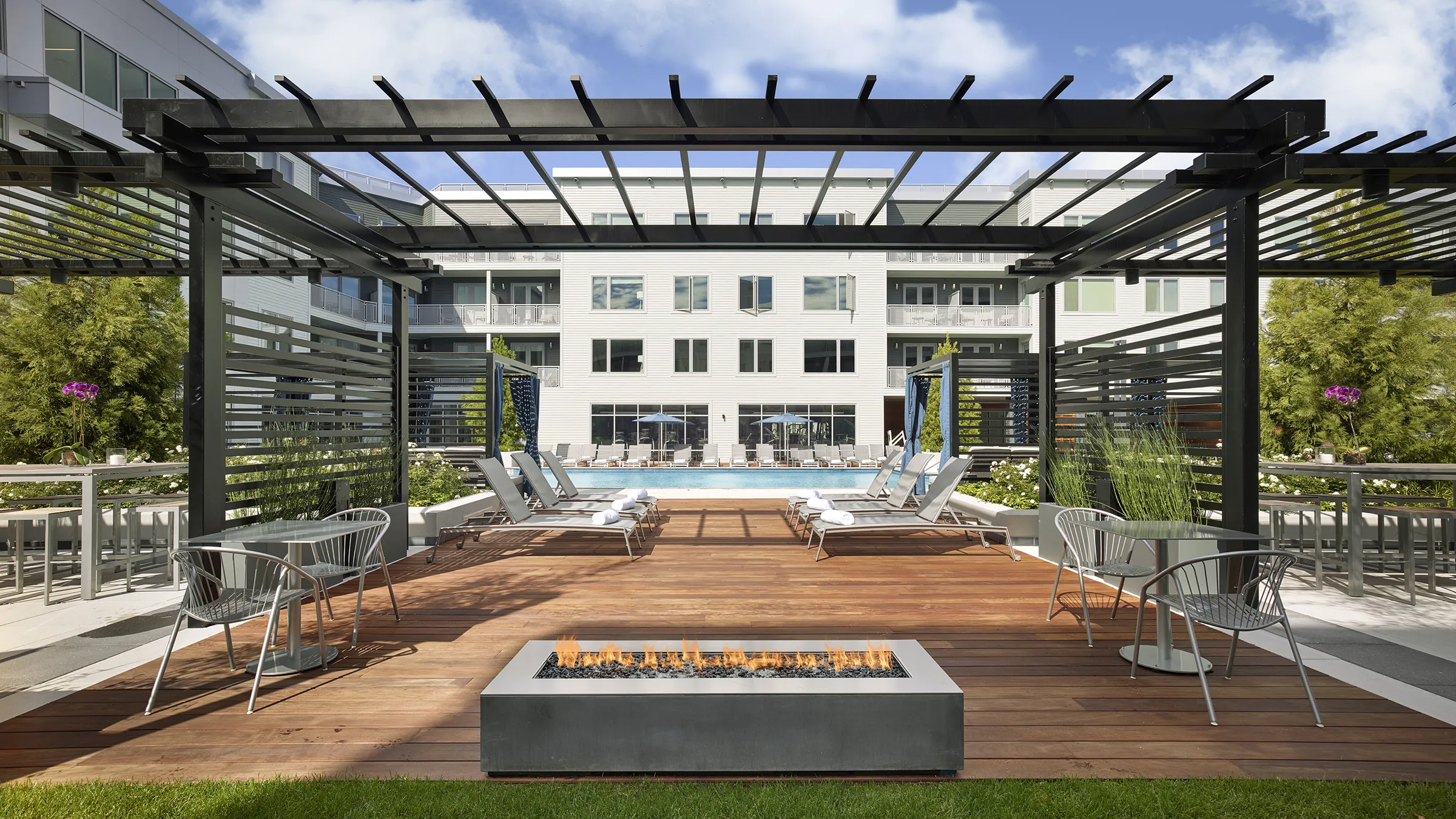 a fire pit and lounge chairs on a deck