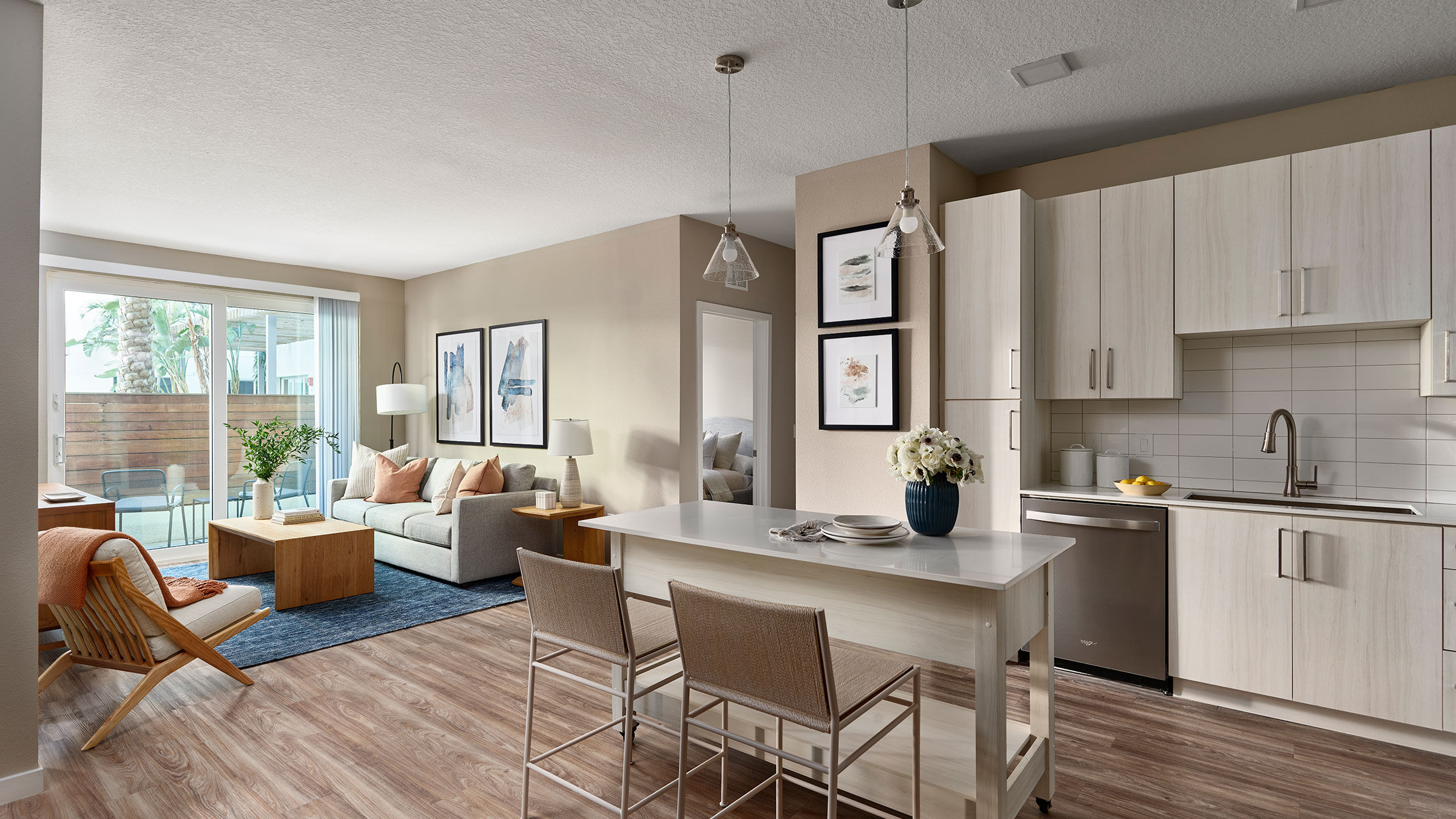 a kitchen and living room with a table and chairs
