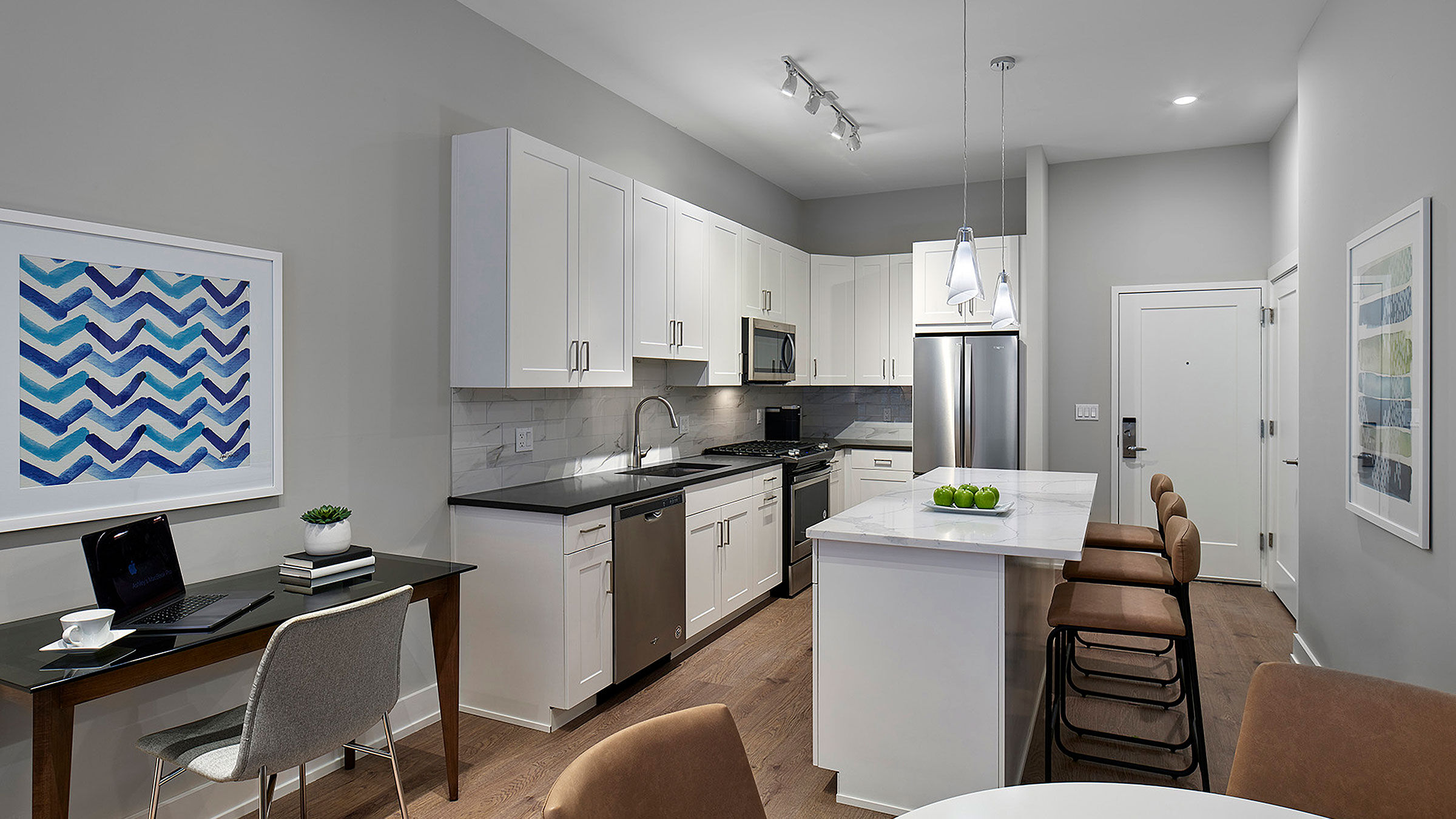 a kitchen with white cabinets and a table
