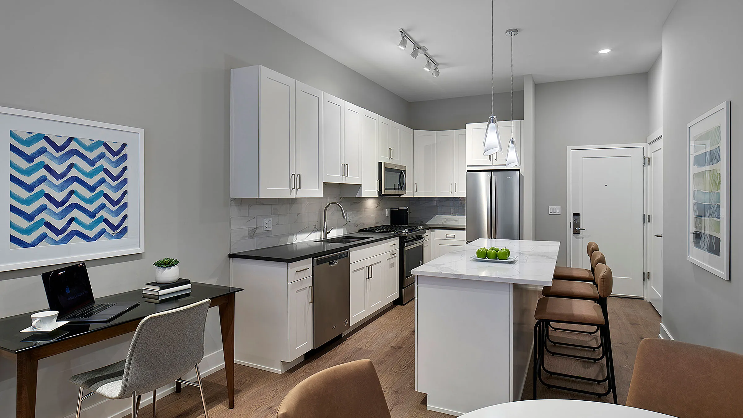 a kitchen with white cabinets and a table