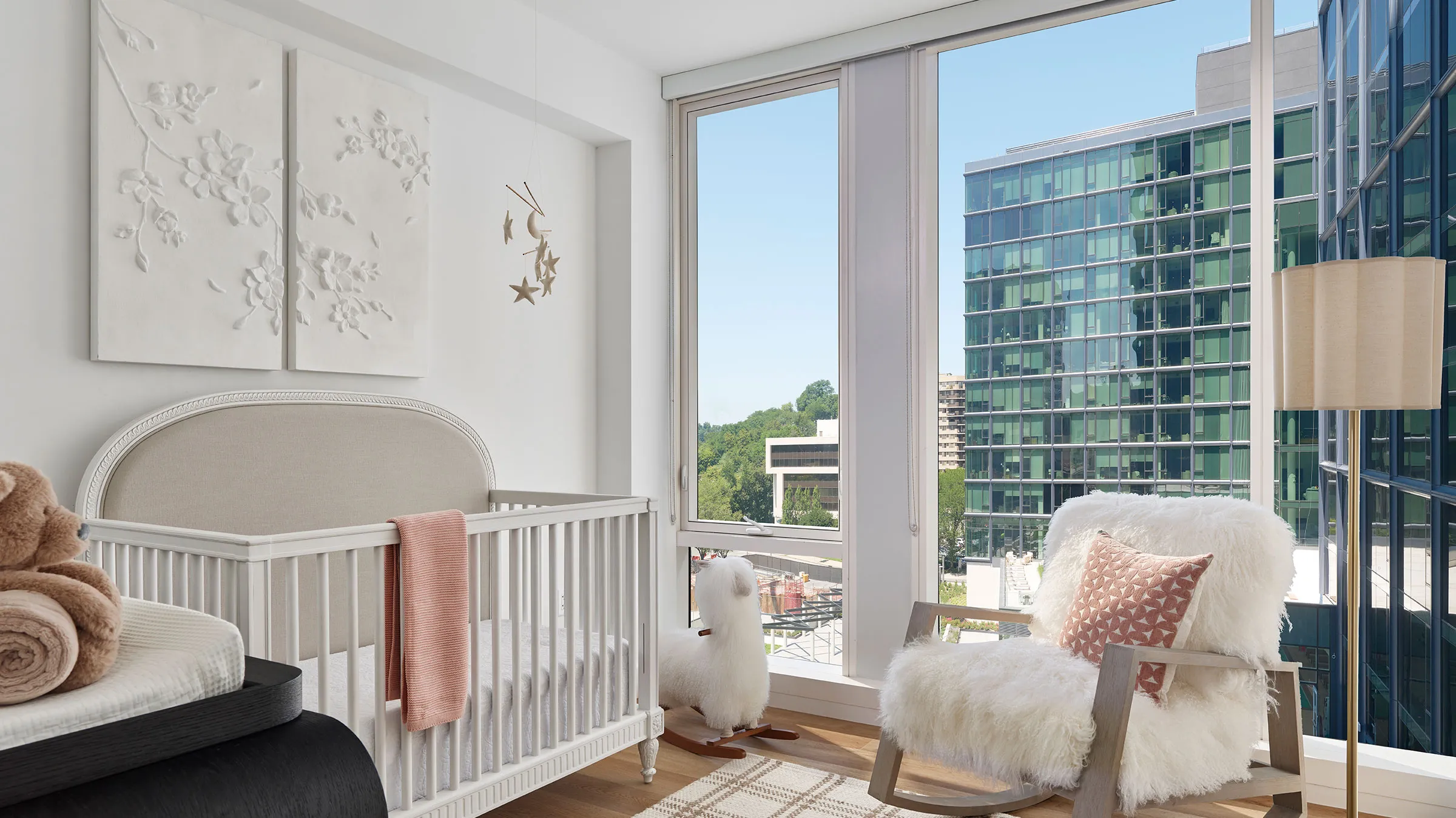 a room with a crib and a rocking chair