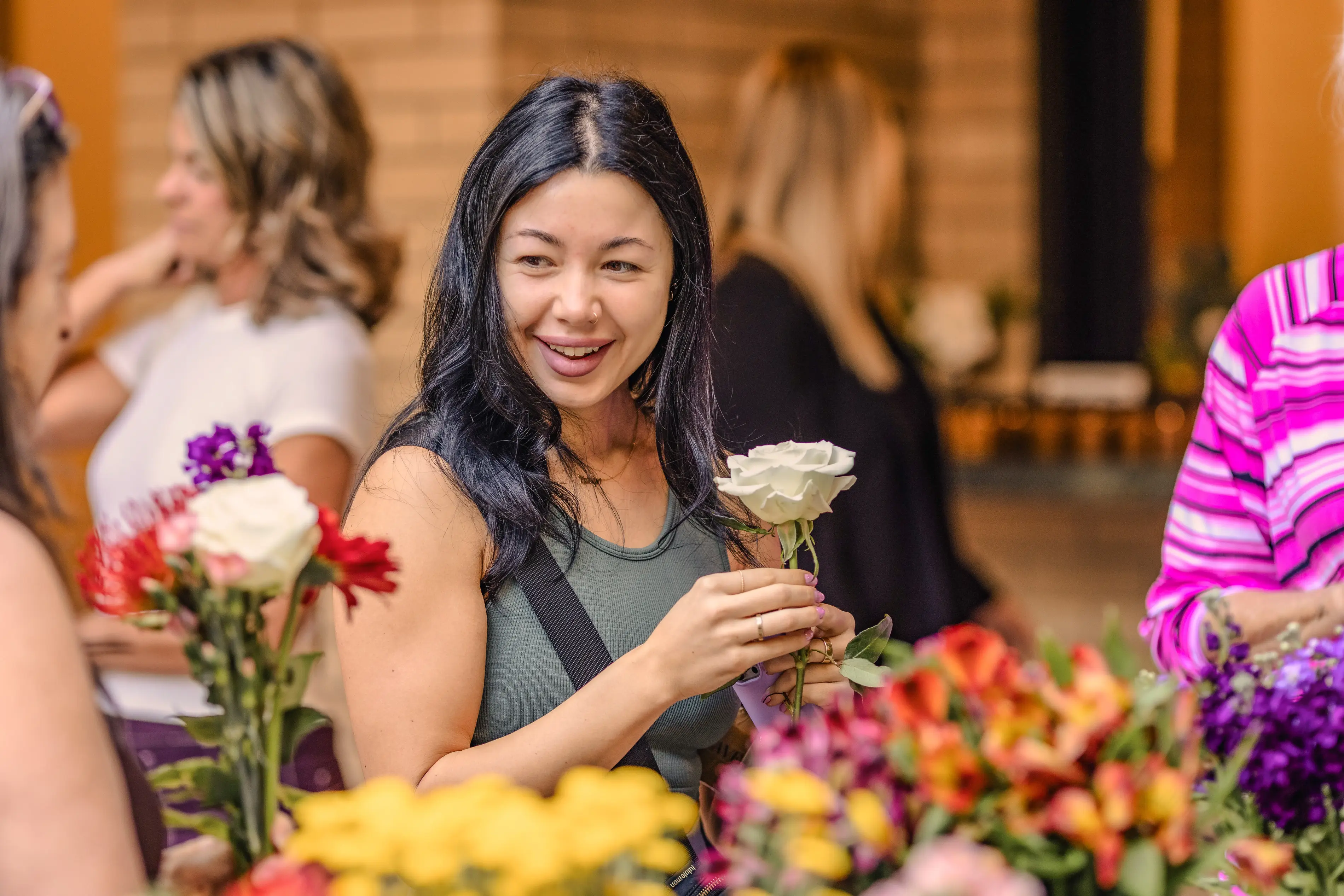 a woman holding a white and yellow rose