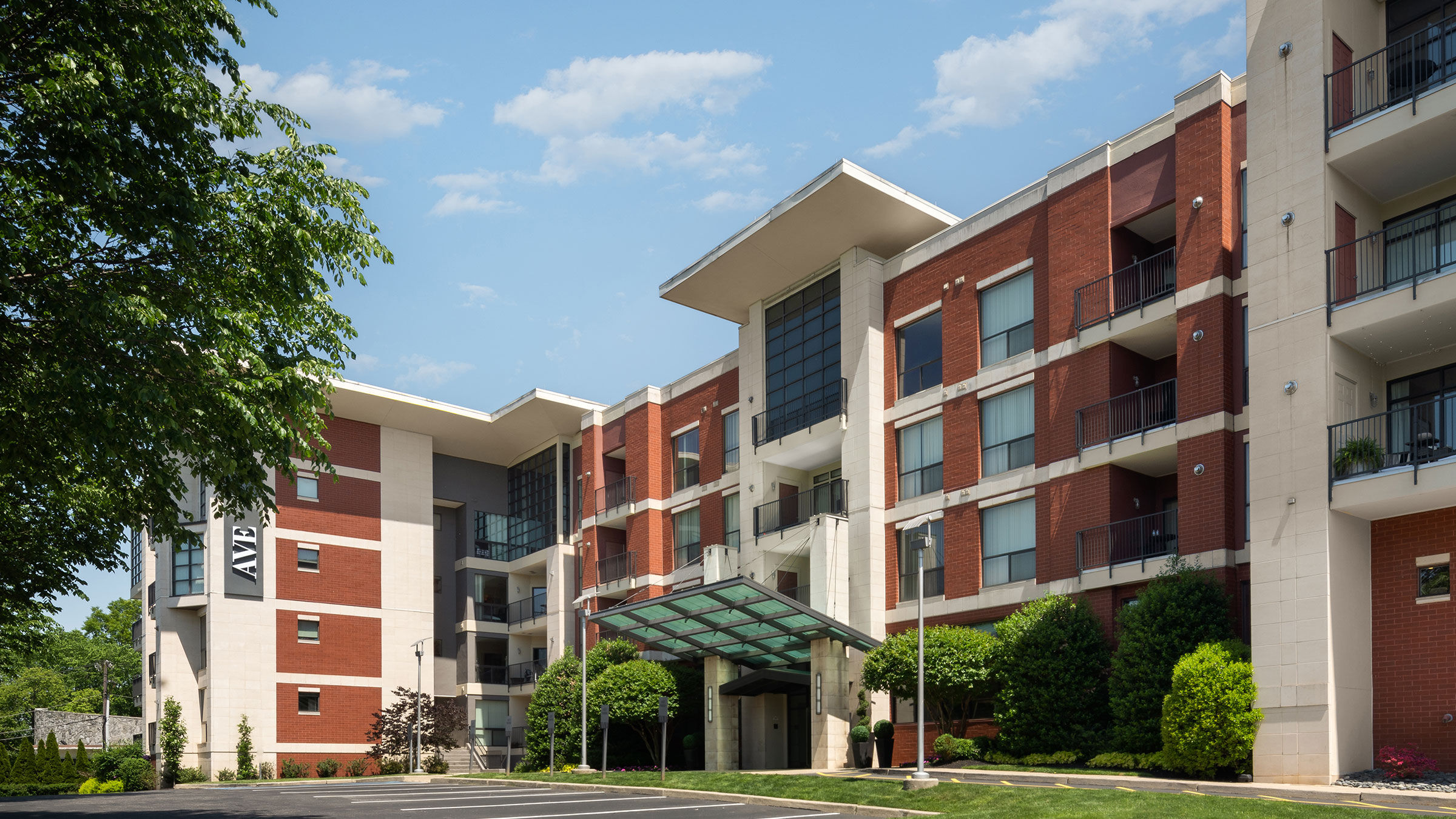 a building with trees and a parking lot