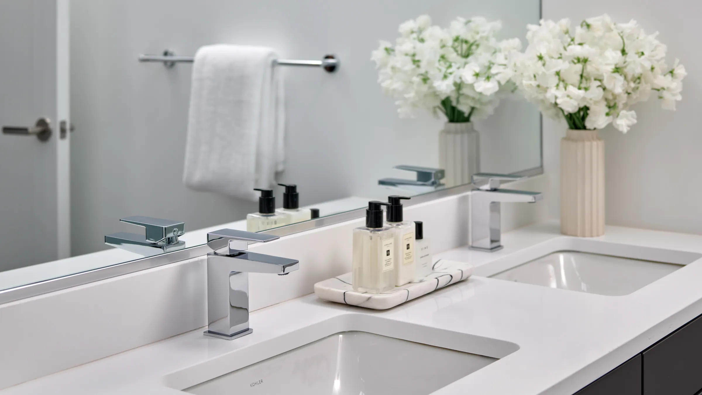 a bathroom sink with faucets and soap bottles