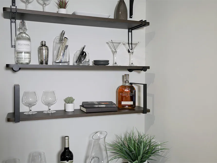 a shelf with wine glasses and bottles