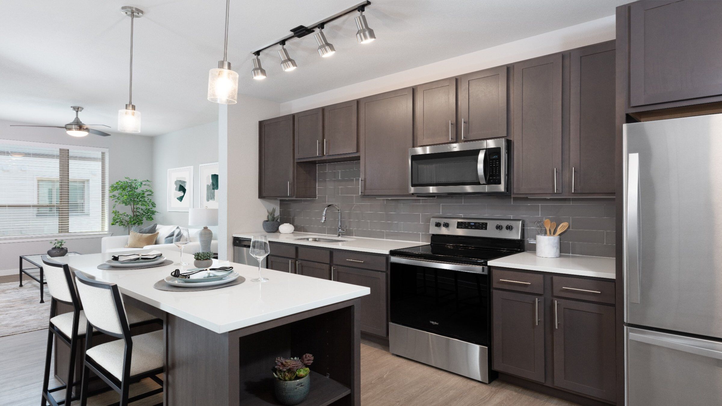 a kitchen with a white island and gray cabinets