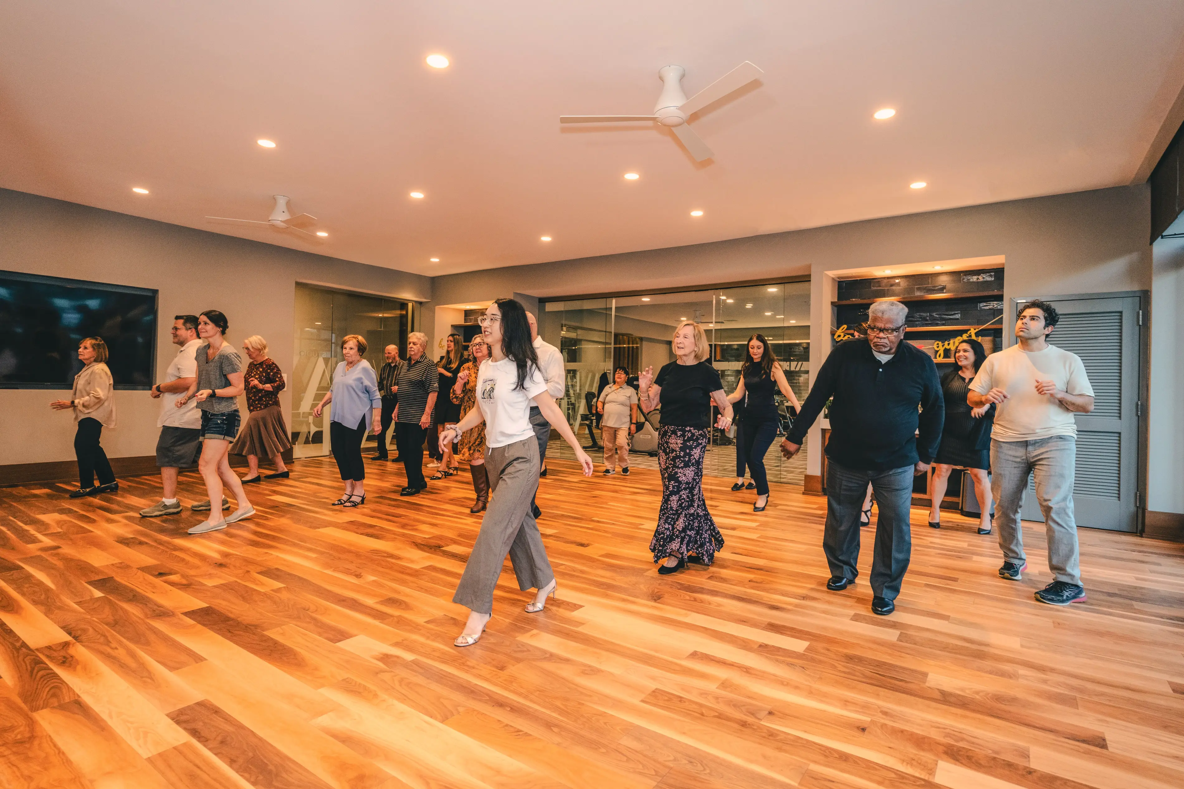 a group of people dancing in a room