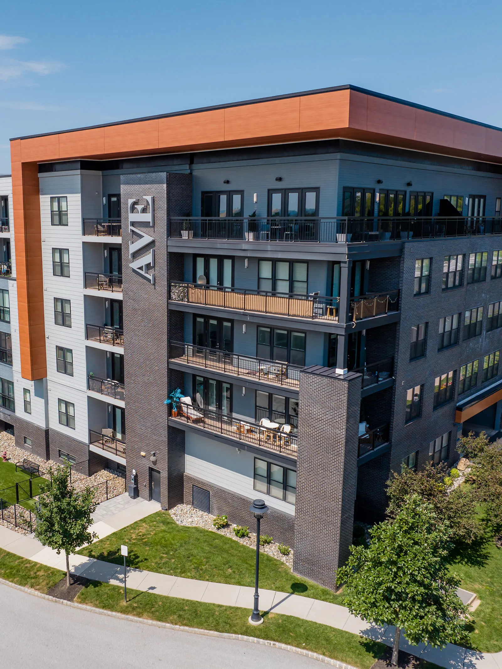 a building with a lawn and trees