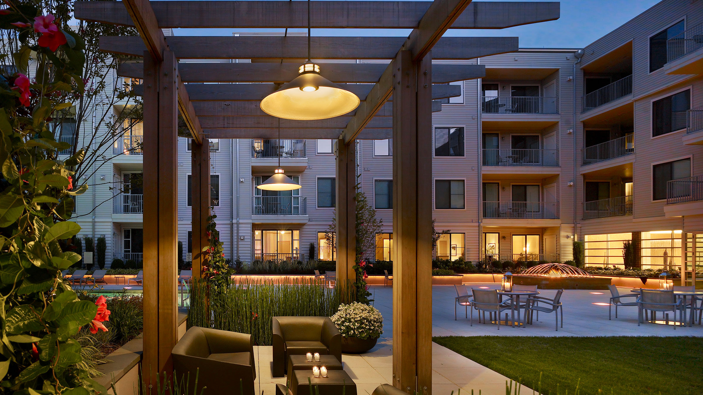 a patio with a pergola and chairs and tables