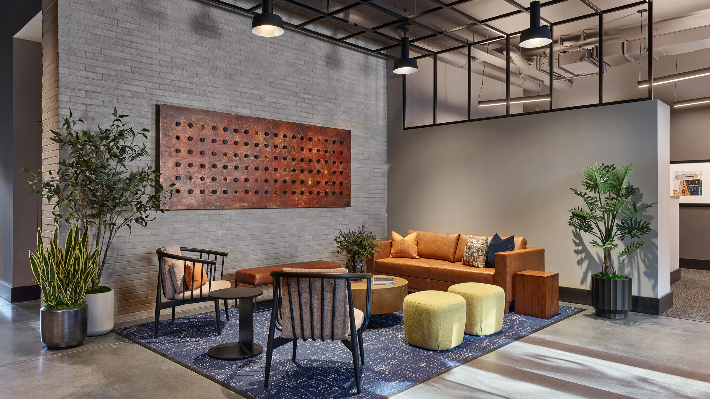 a room with a couch and chairs