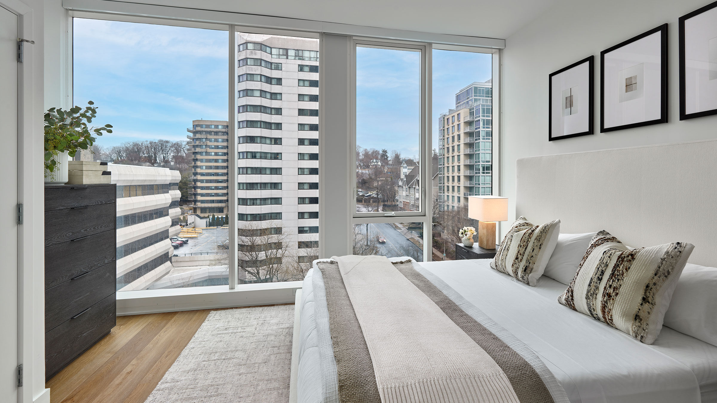 a bedroom with large windows and a large bed