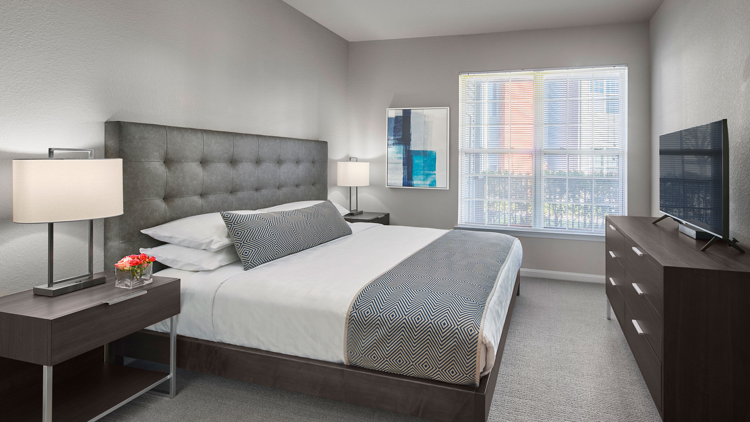 a bedroom with a bed and a window