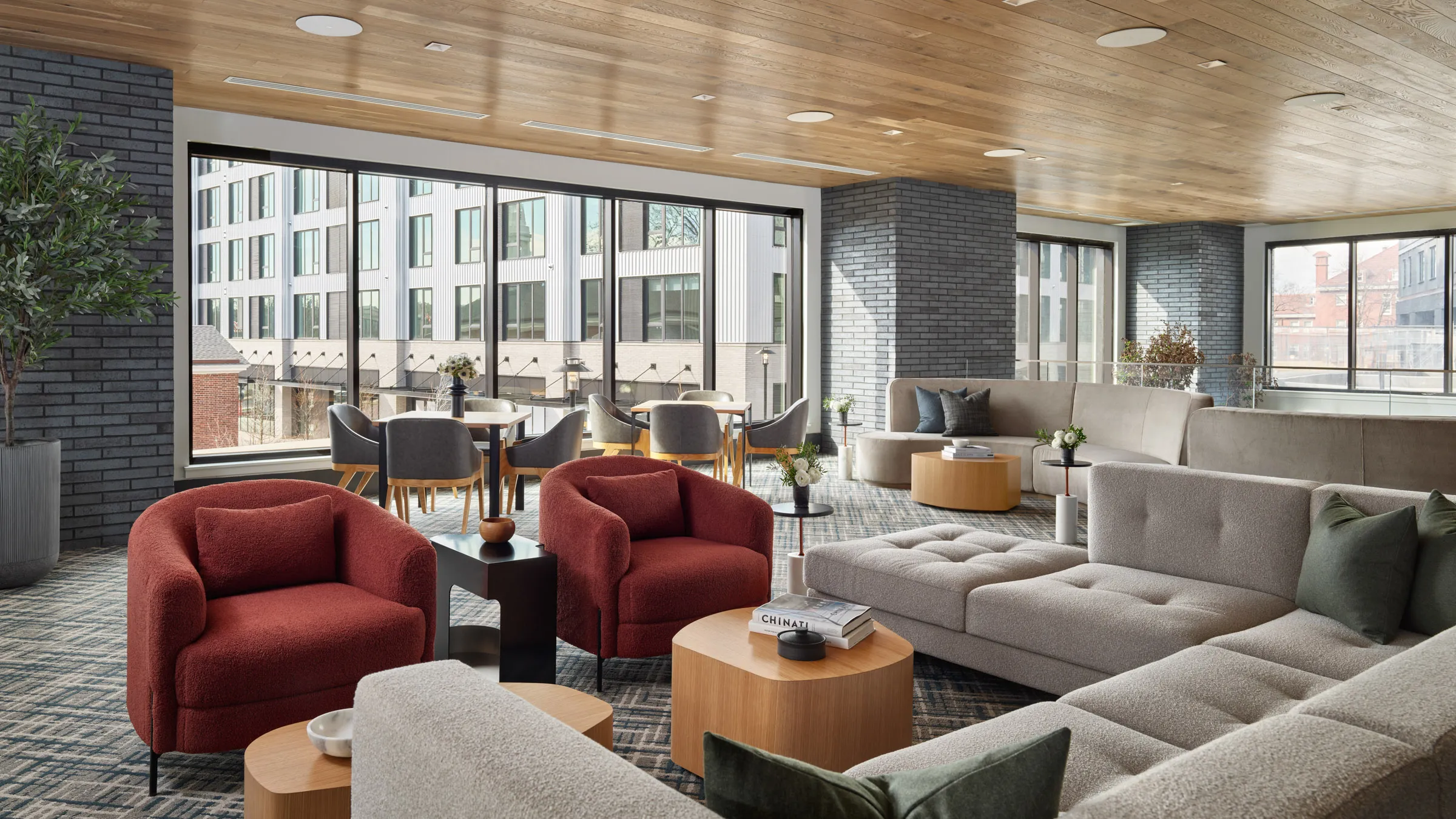 a room with a large group of couches and tables