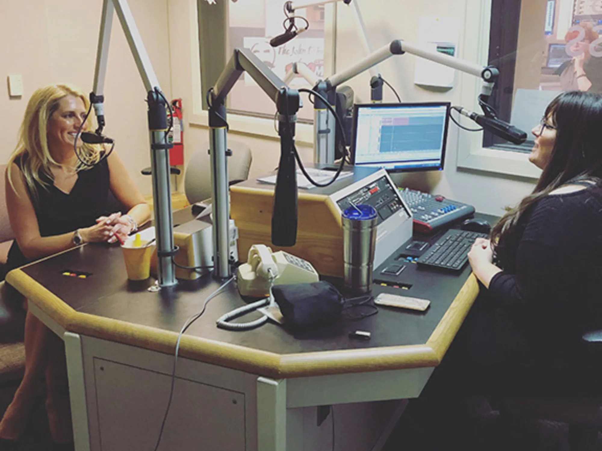 Two women recording a podcast