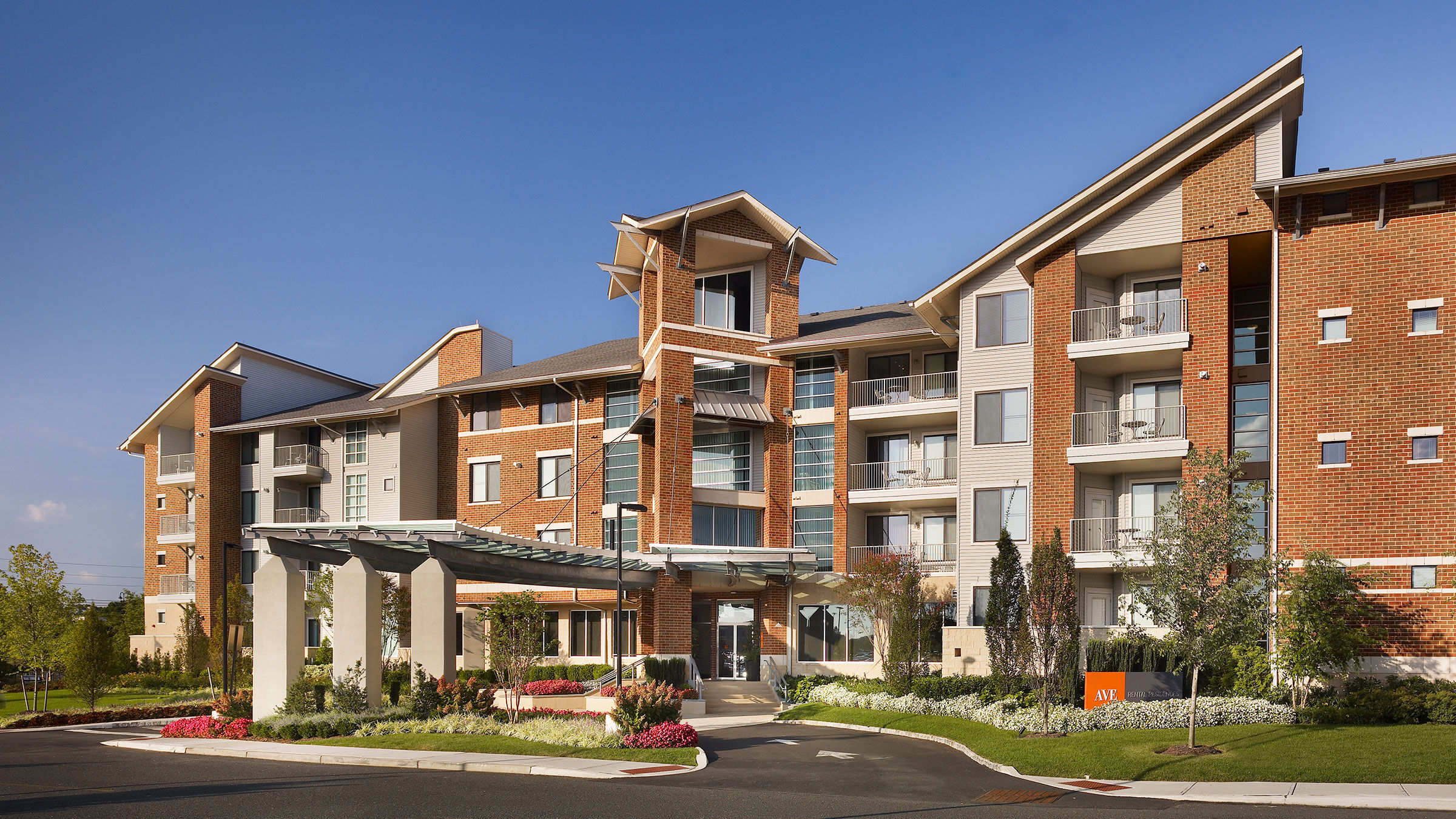 a building with a driveway and a parking lot