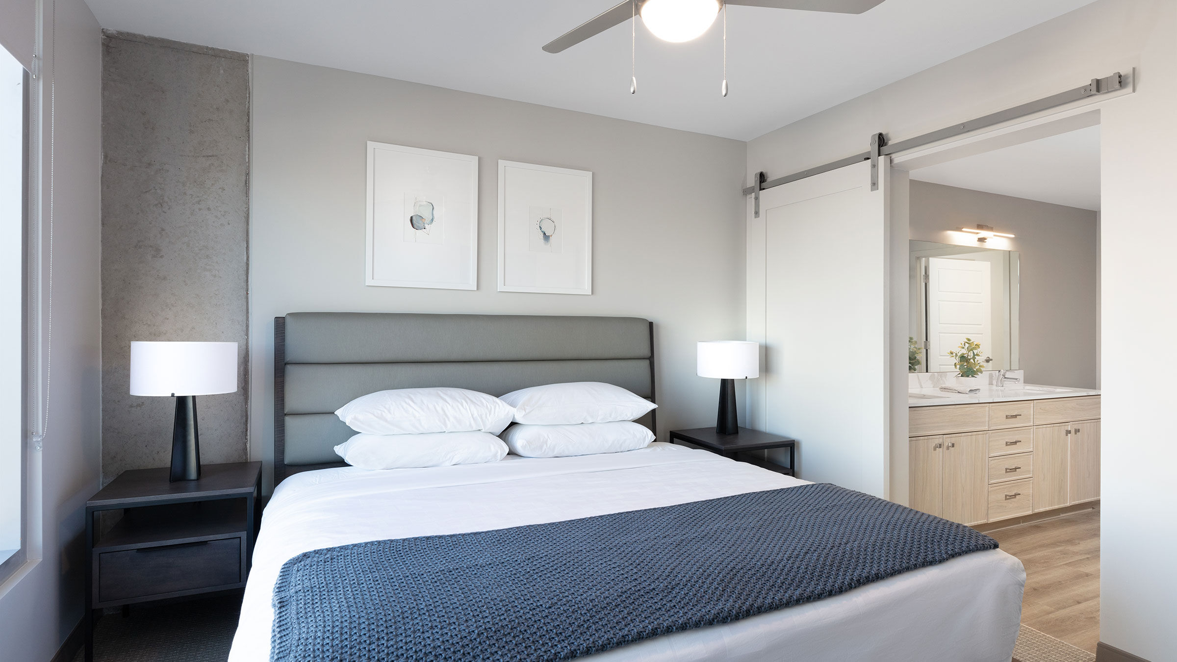 a bed with a fan and a ceiling fan