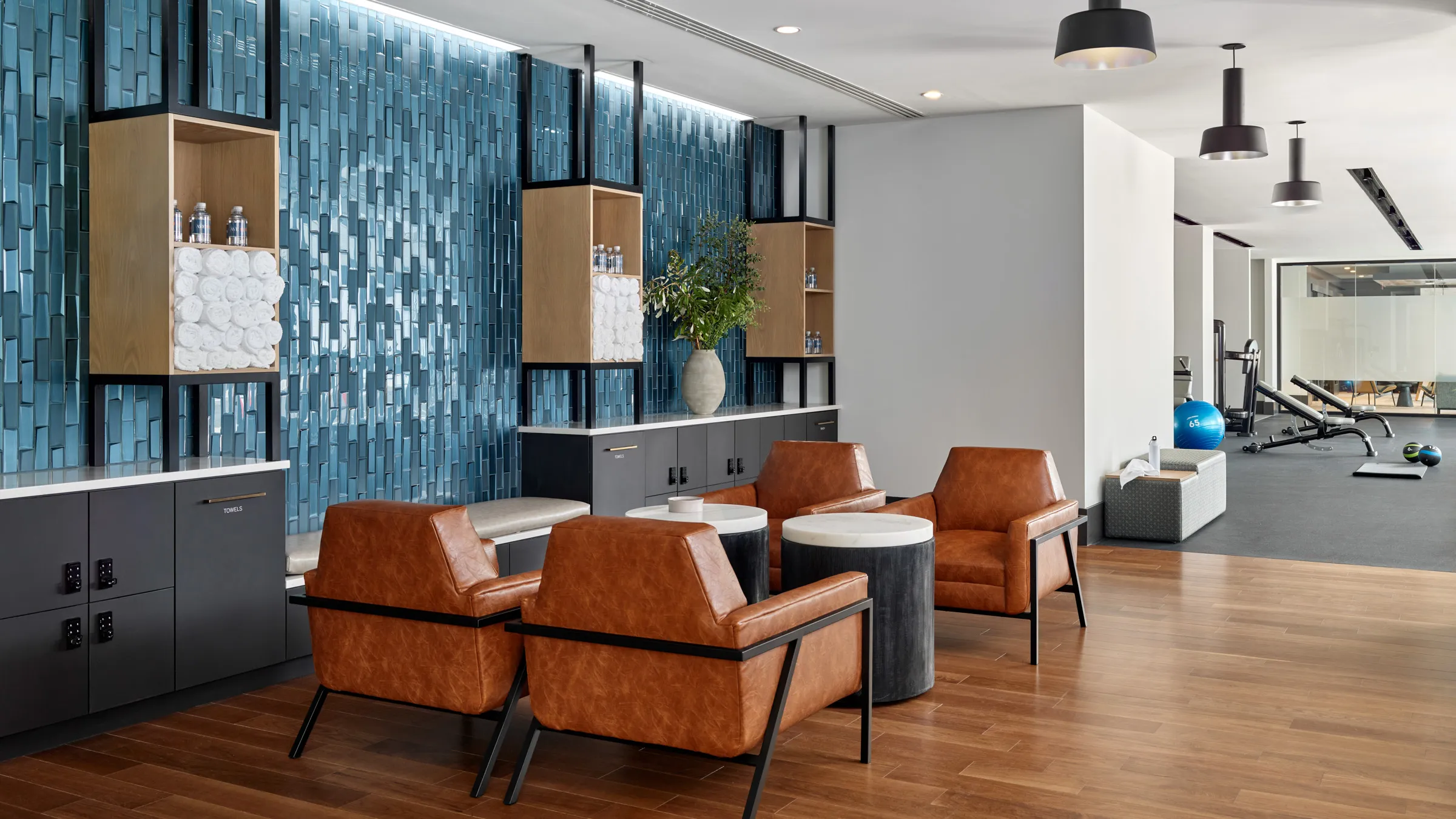 a room with brown chairs and a blue wall