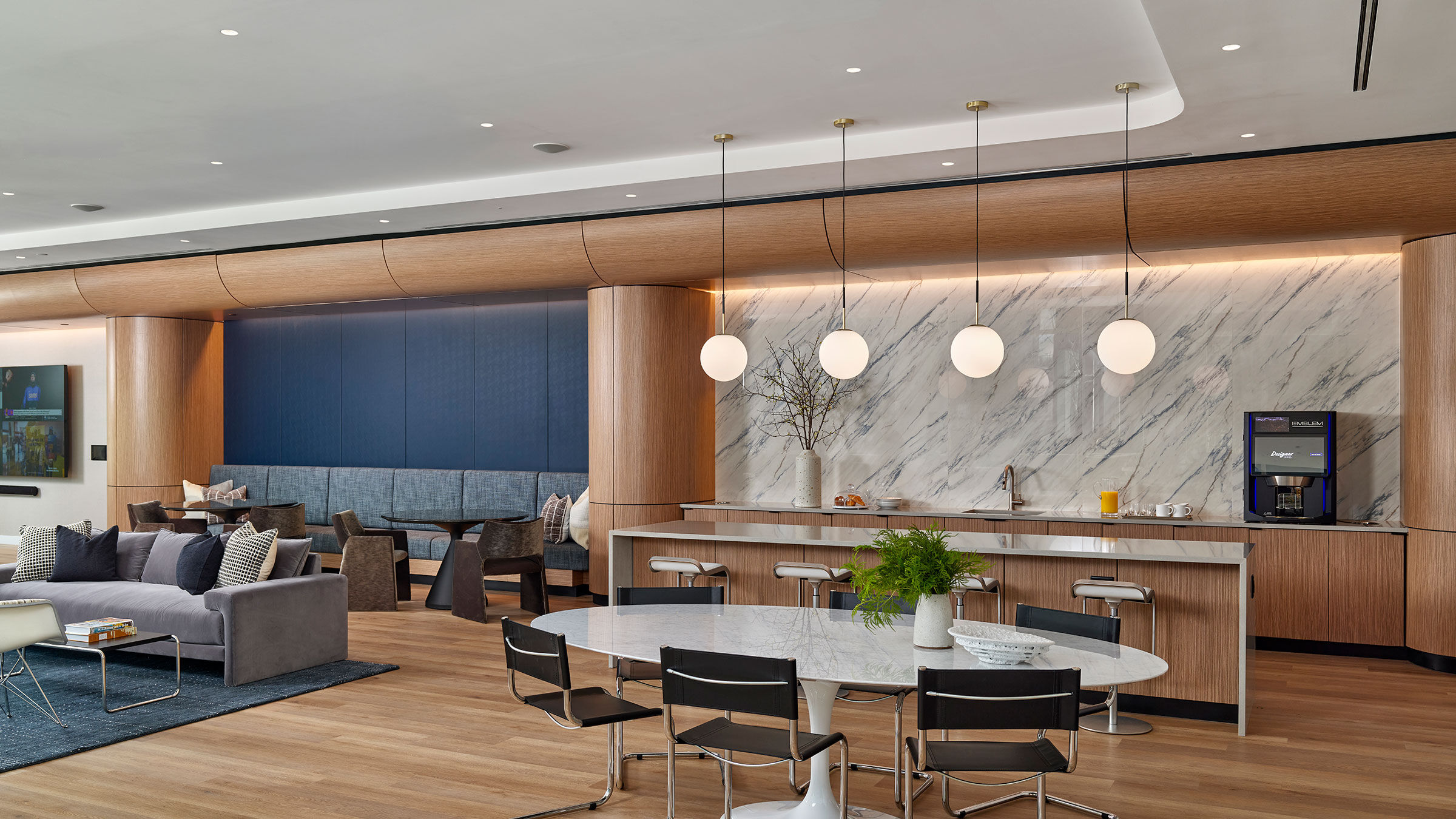 a room with a marble counter and a table with chairs
