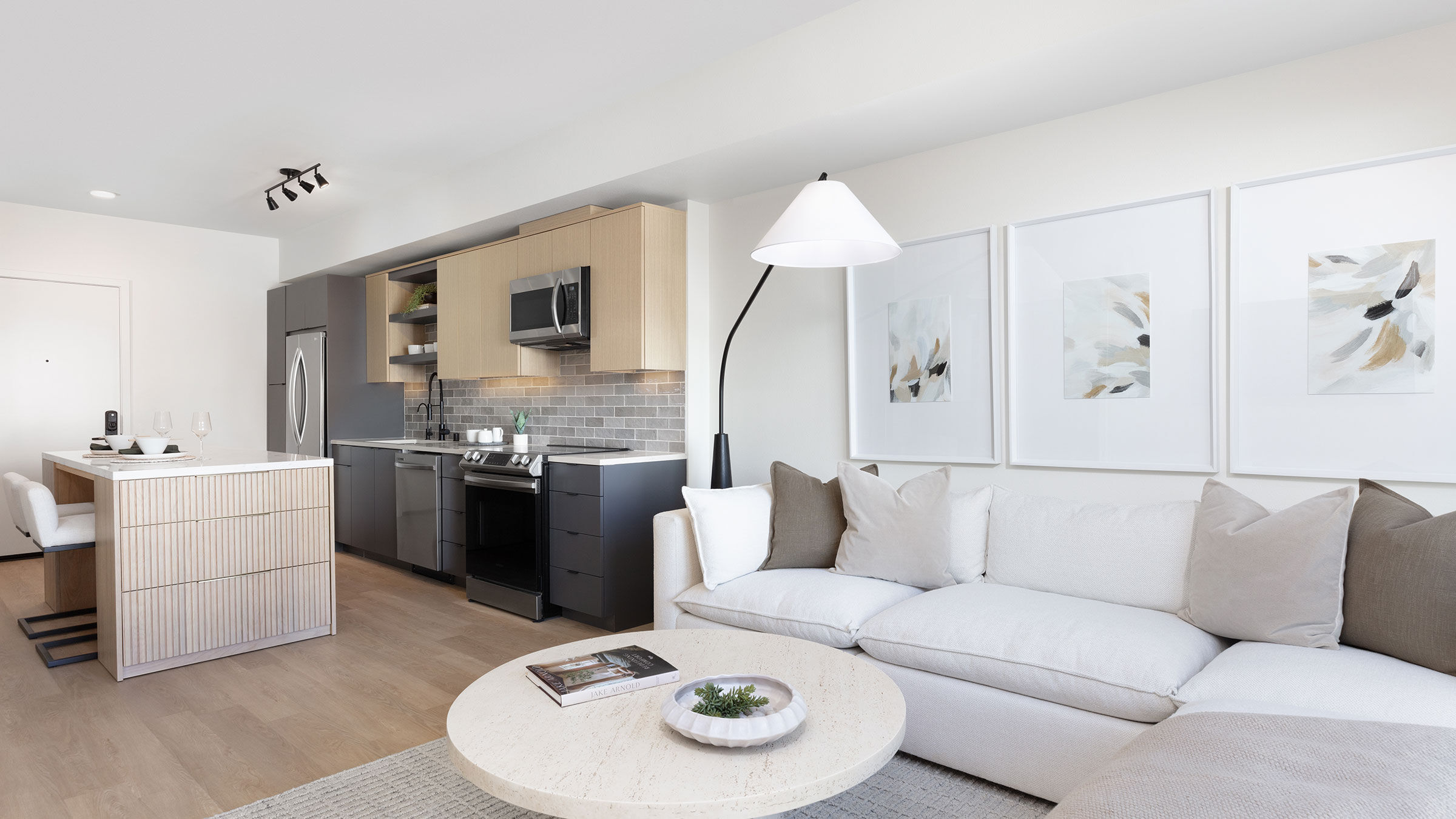 a living room with a white couch and a white table