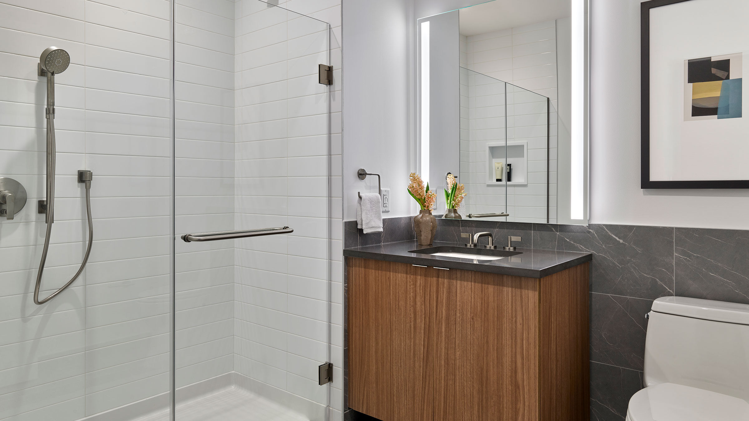 a bathroom with a glass shower and sink