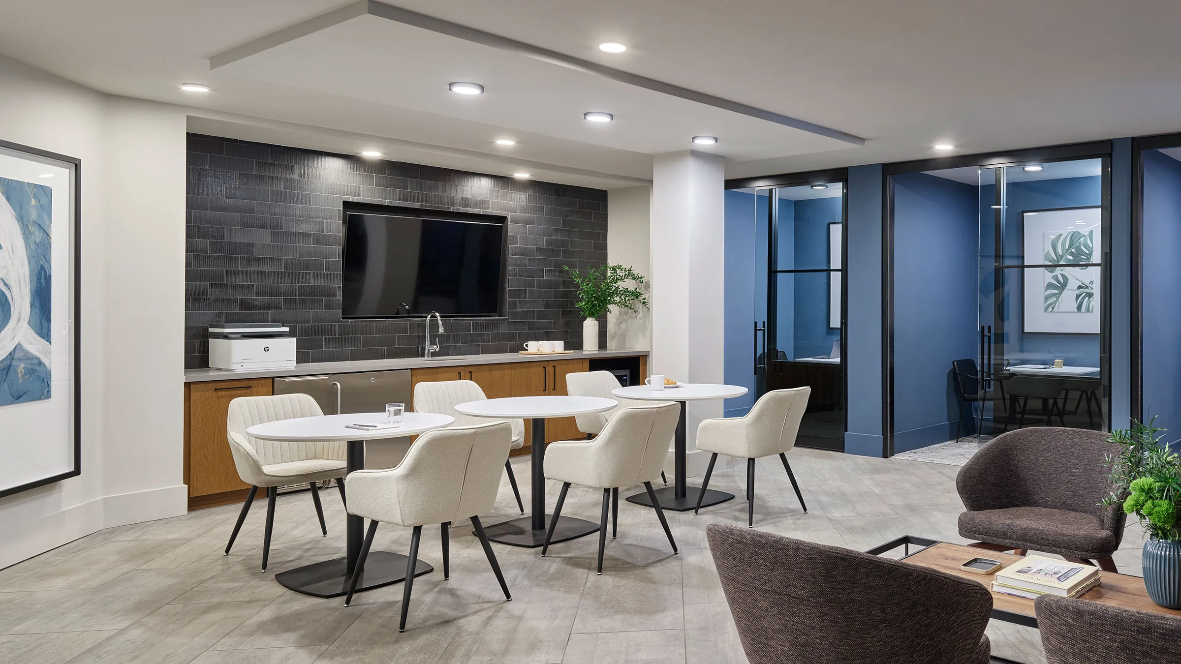 a room with white tables and chairs