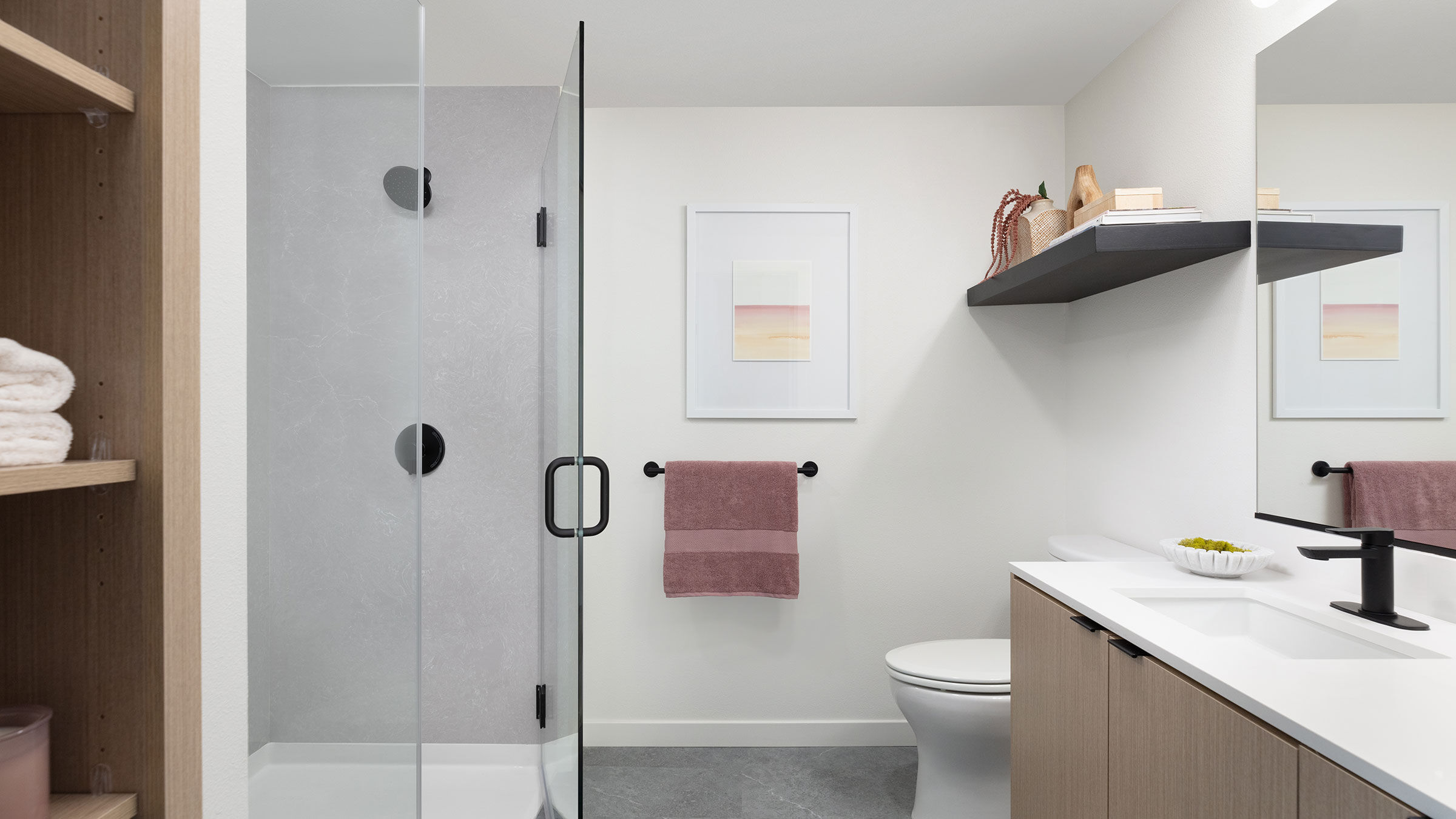 a bathroom with a glass shower door and sink