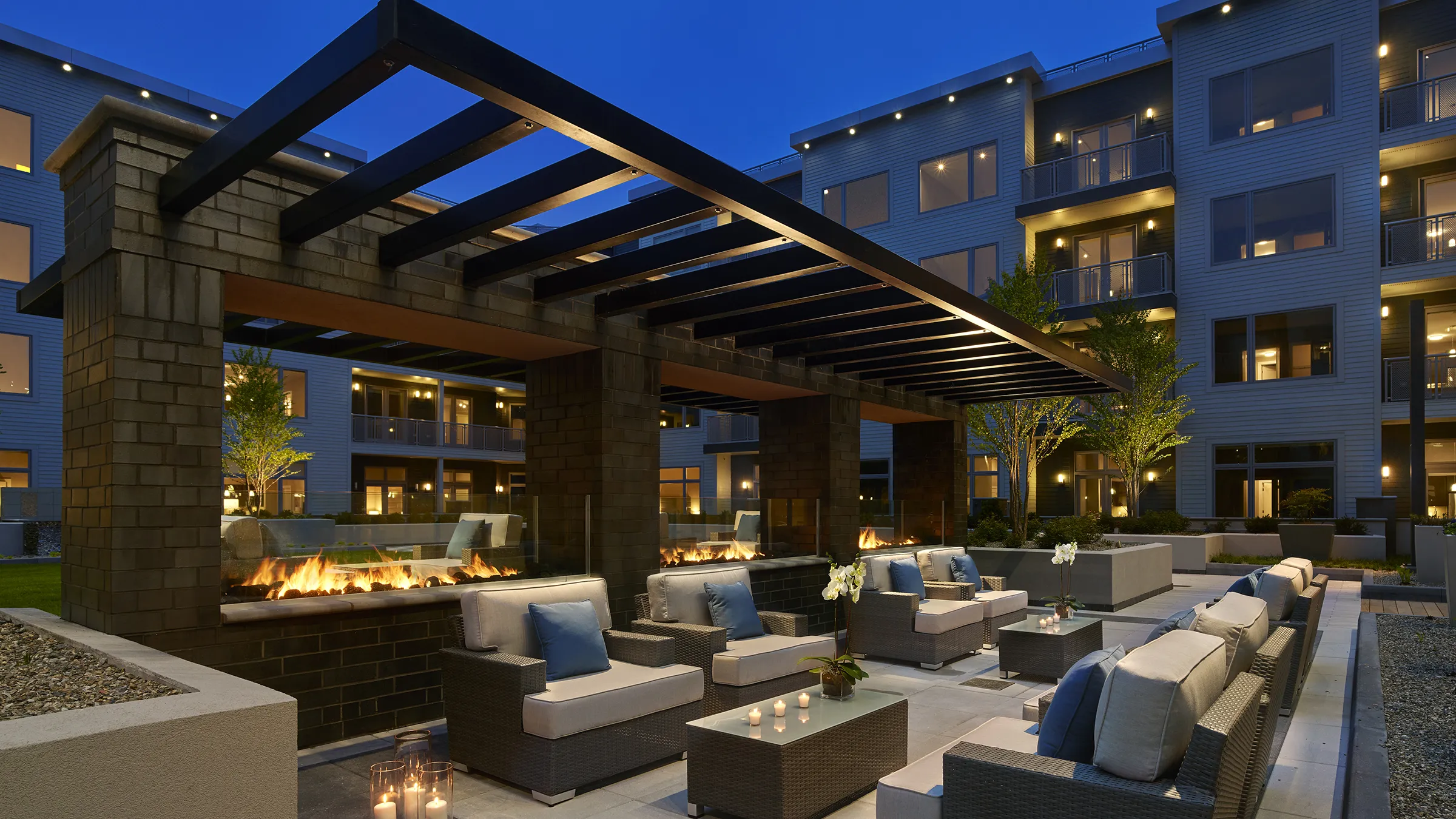 a patio area with chairs and tables and candles