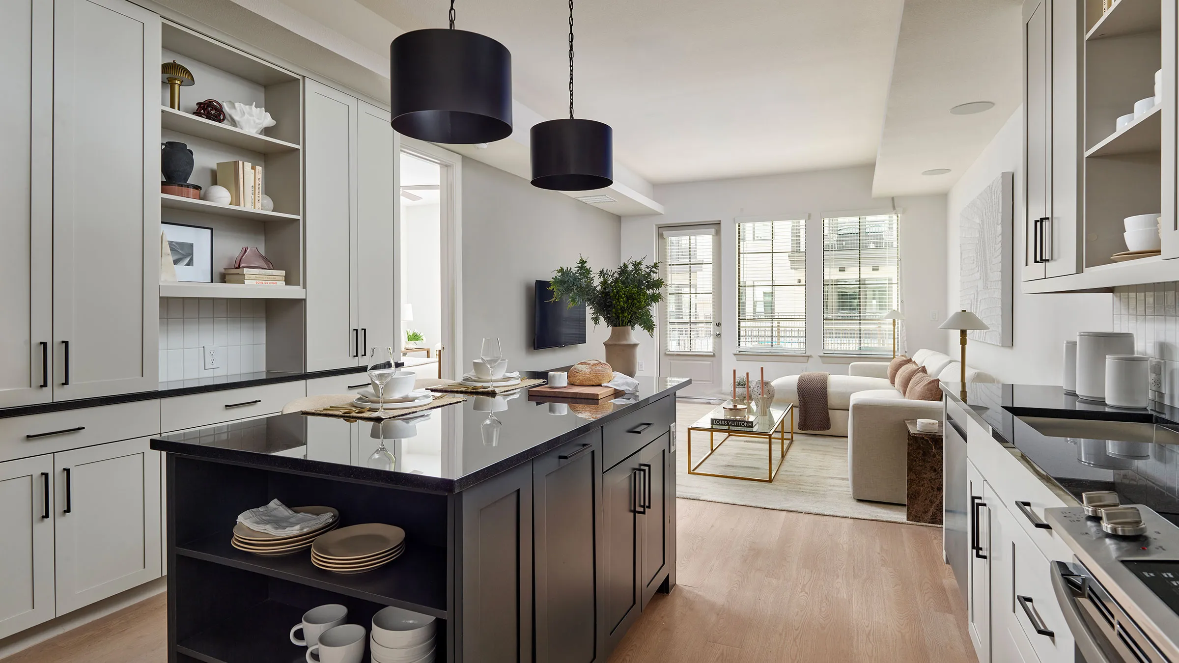 a kitchen with a black countertop and a couch