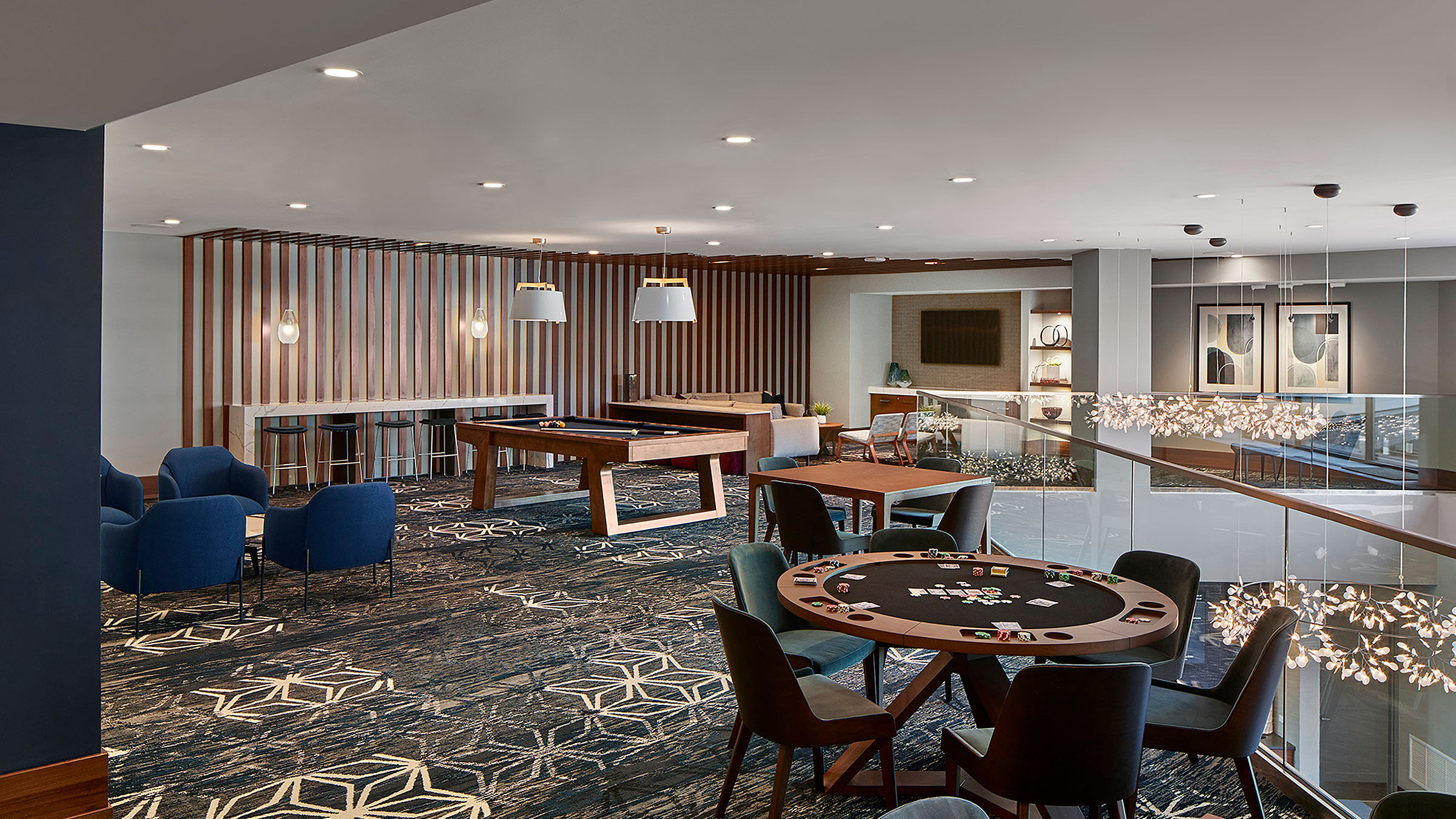 a room with a pool table and chairs