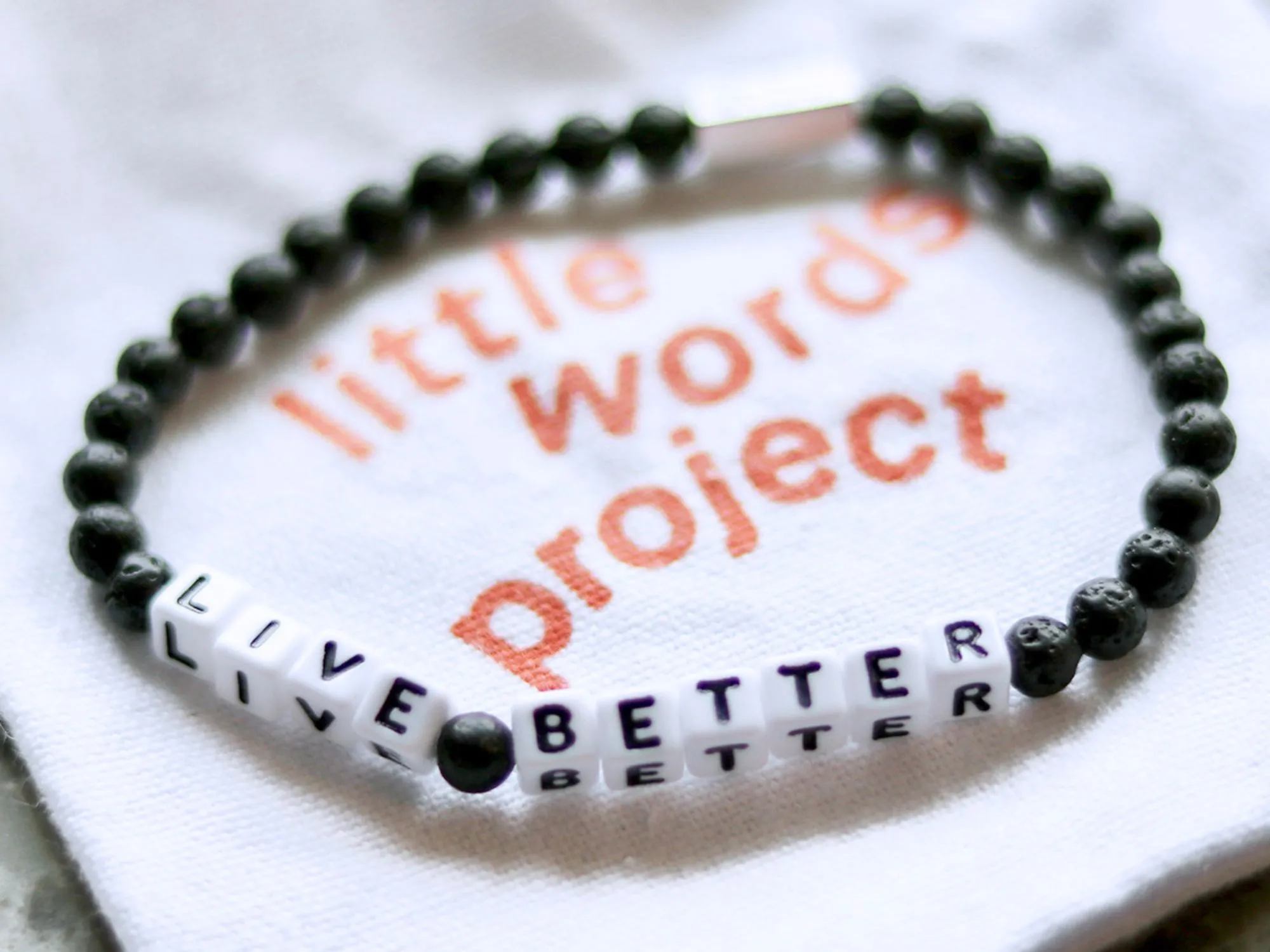 A Little Words Project bracelet that reads "Live Better."