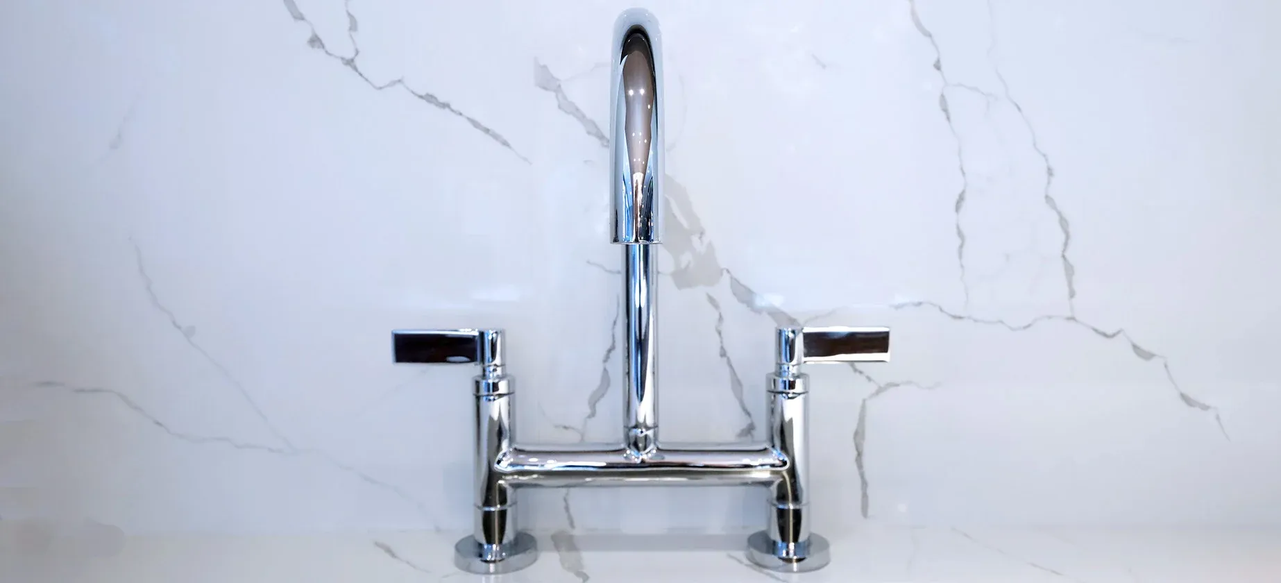 a faucet on a marble counter