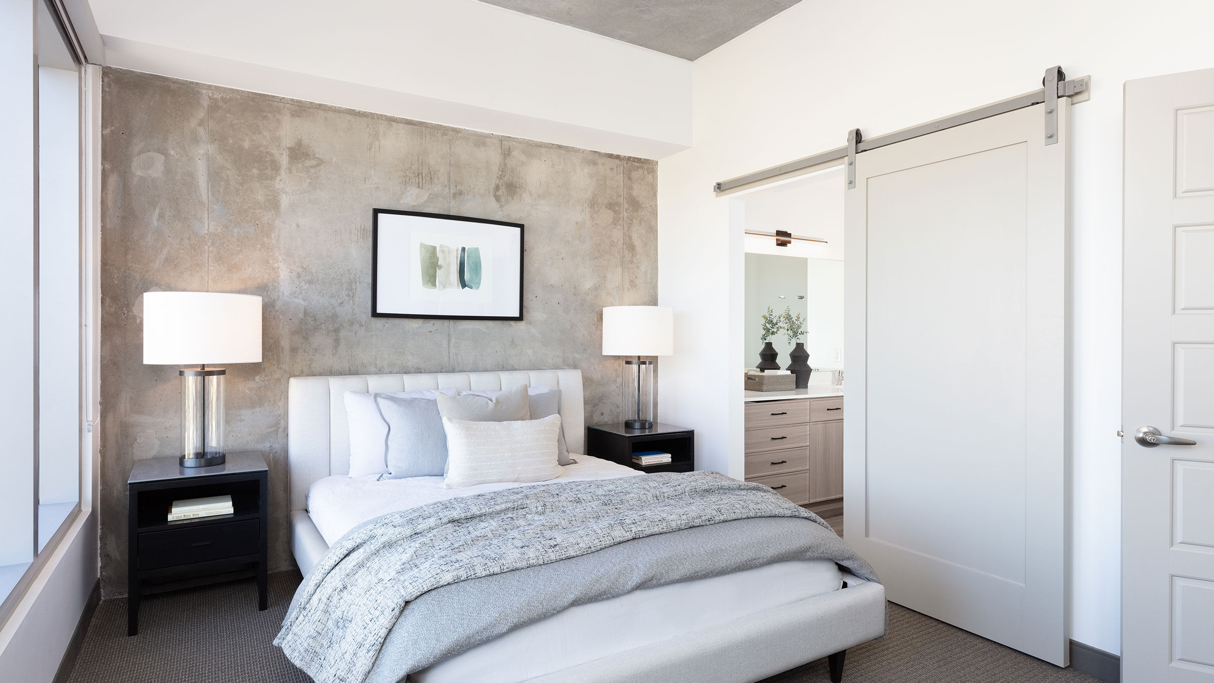 a bed with a white bedding and a white door