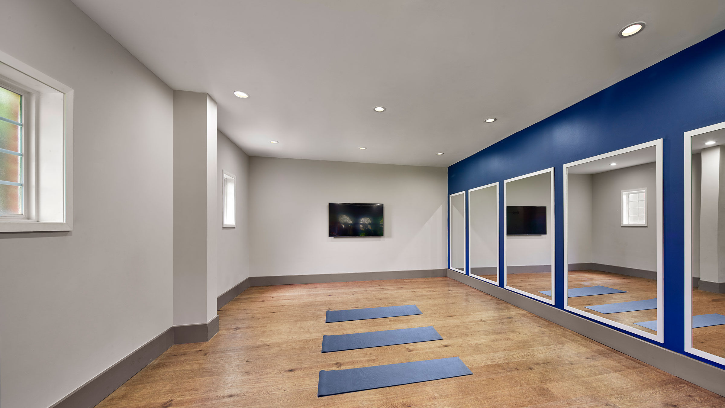 a room with blue mats and mirrors