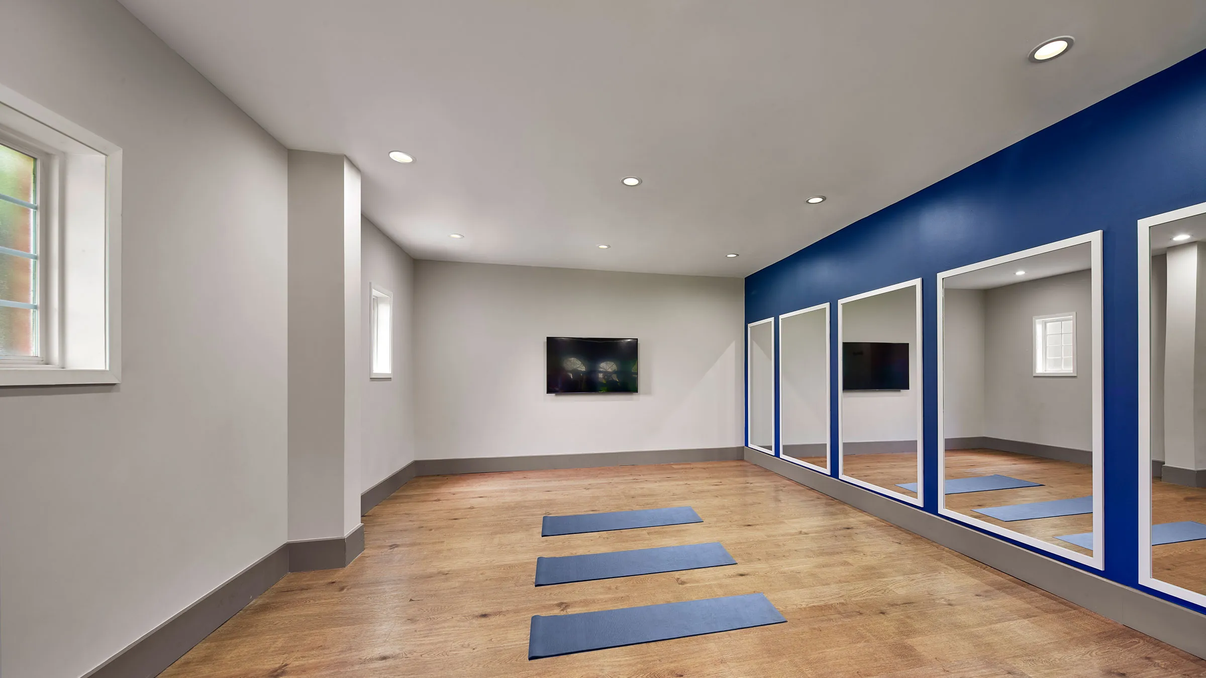 a room with blue mats and mirrors