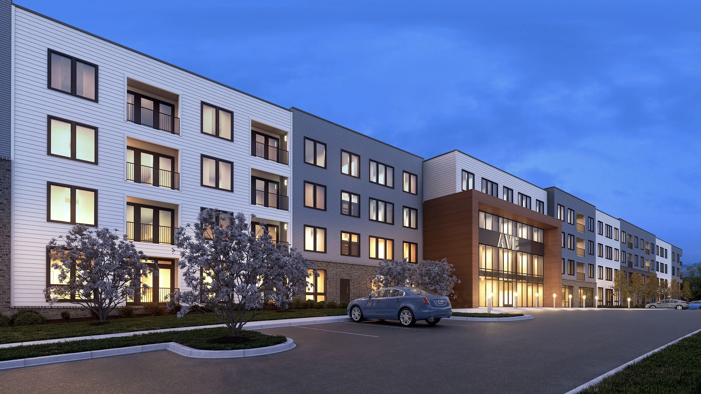 a building with a parking lot and trees