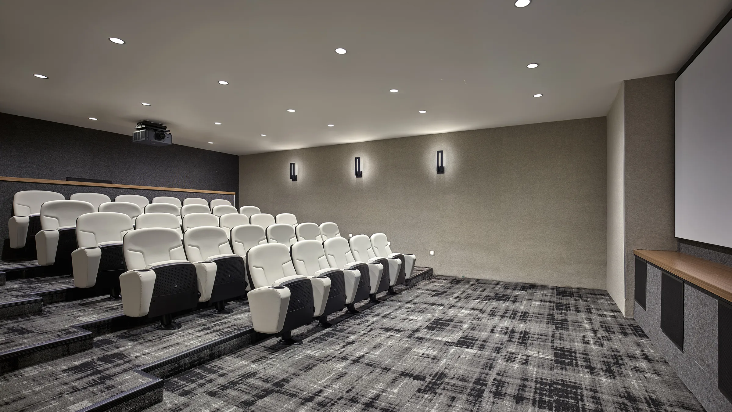a room with white chairs and a carpet