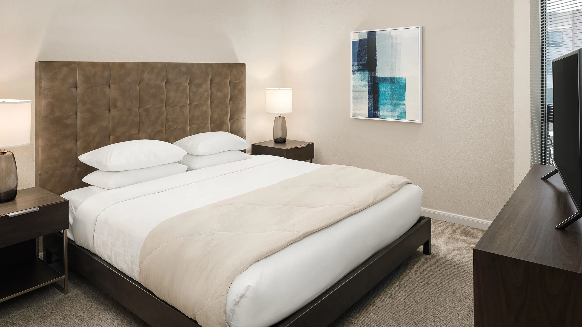 a bed with a lamp on the side