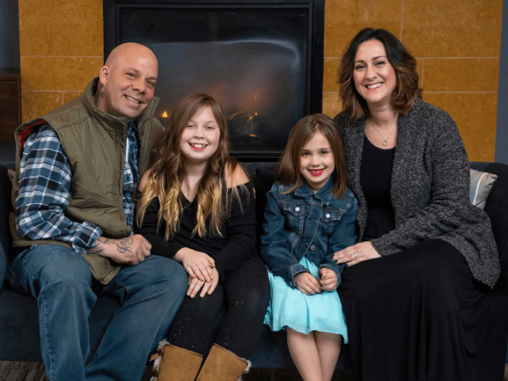 A family sitting in front of a fireplace