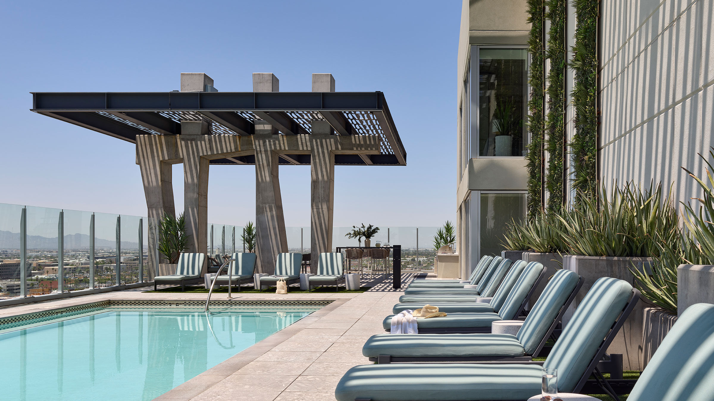a pool with lounge chairs and a building