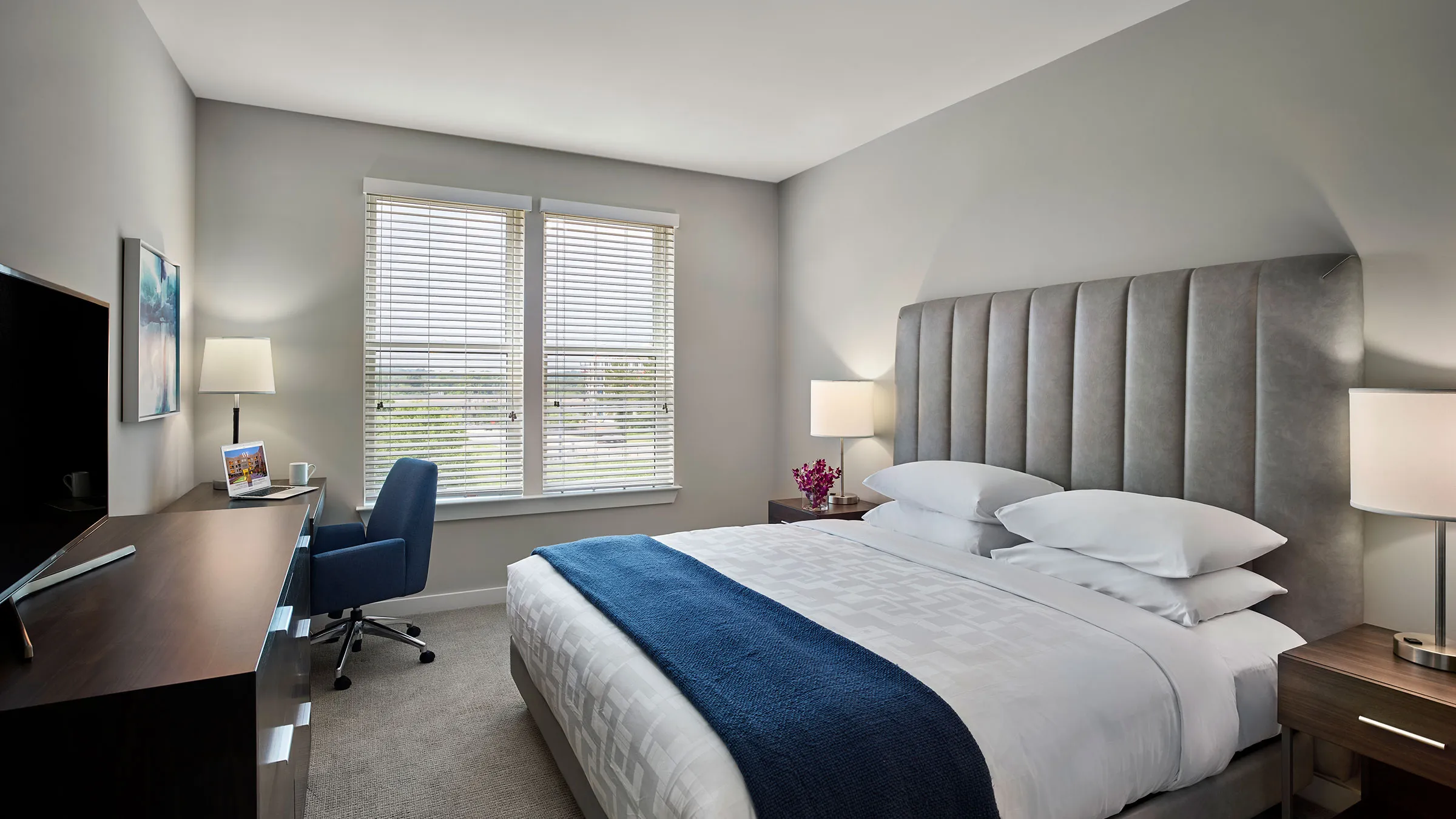 a bedroom with a blue chair and a bed