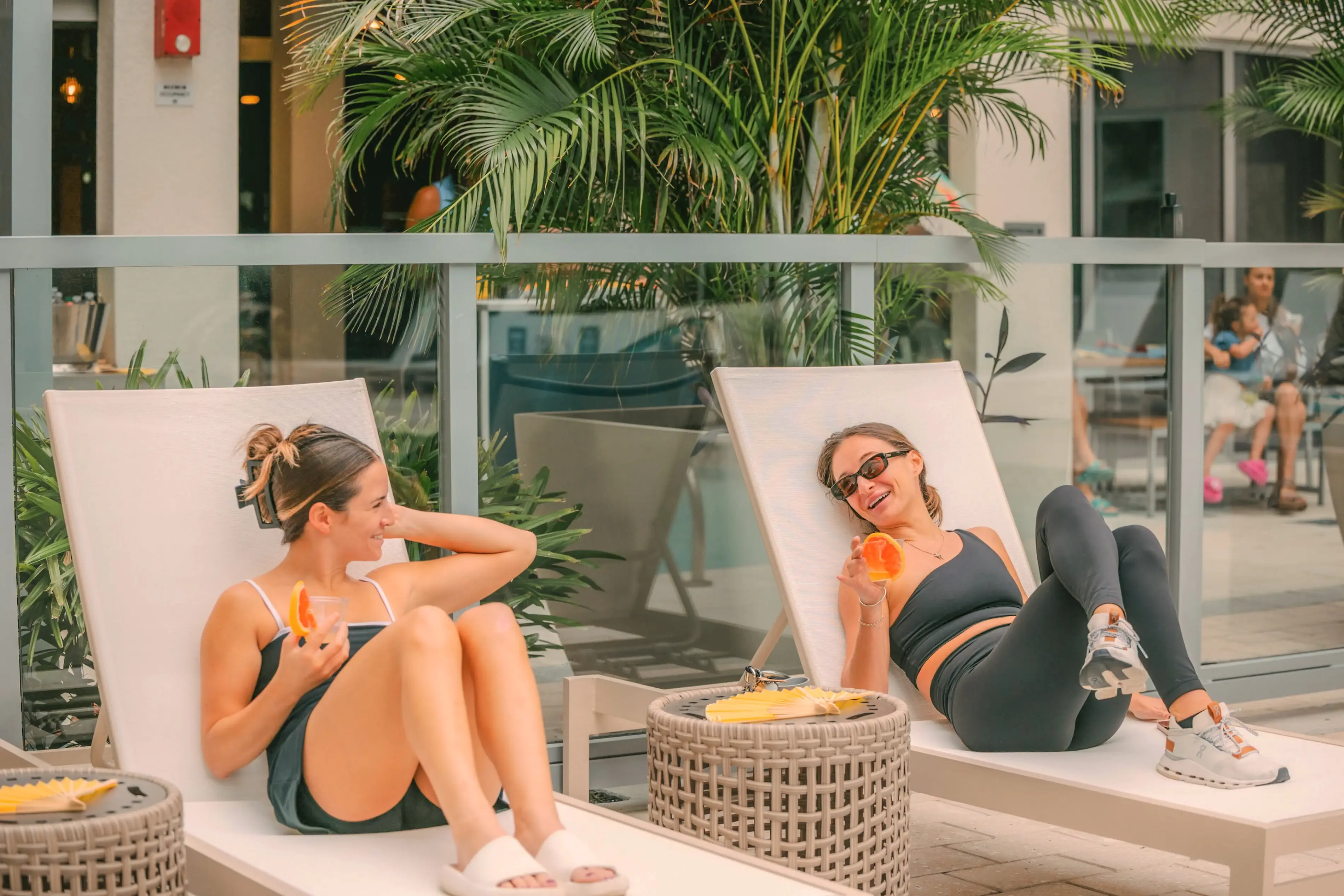a group of women sitting on lounge chairs