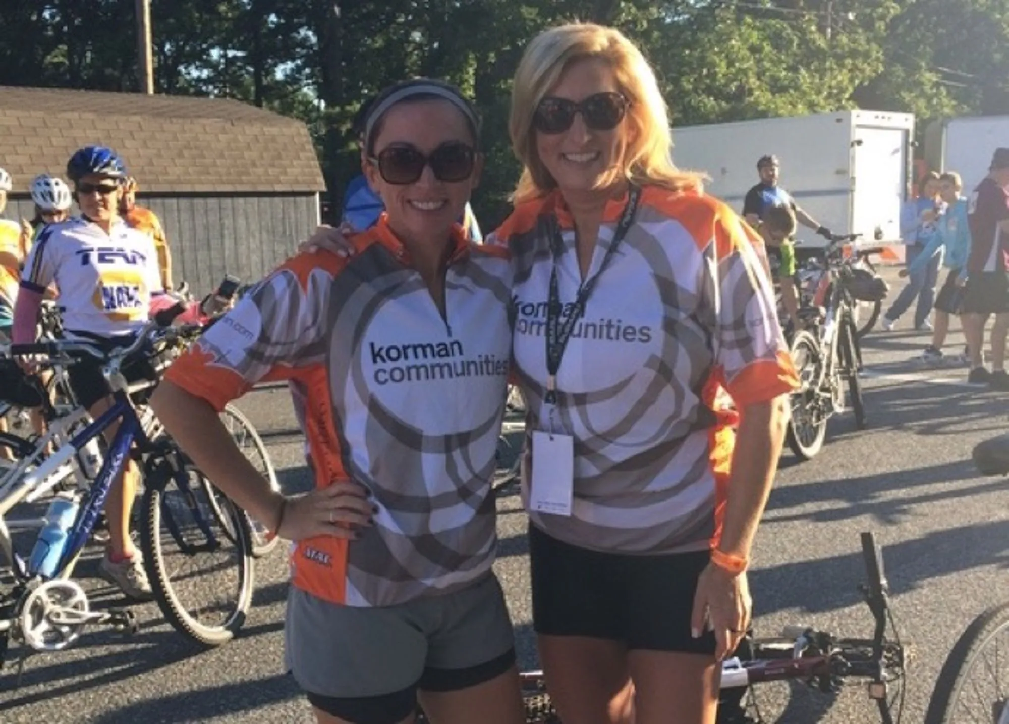 Two women smiling before a bike race 