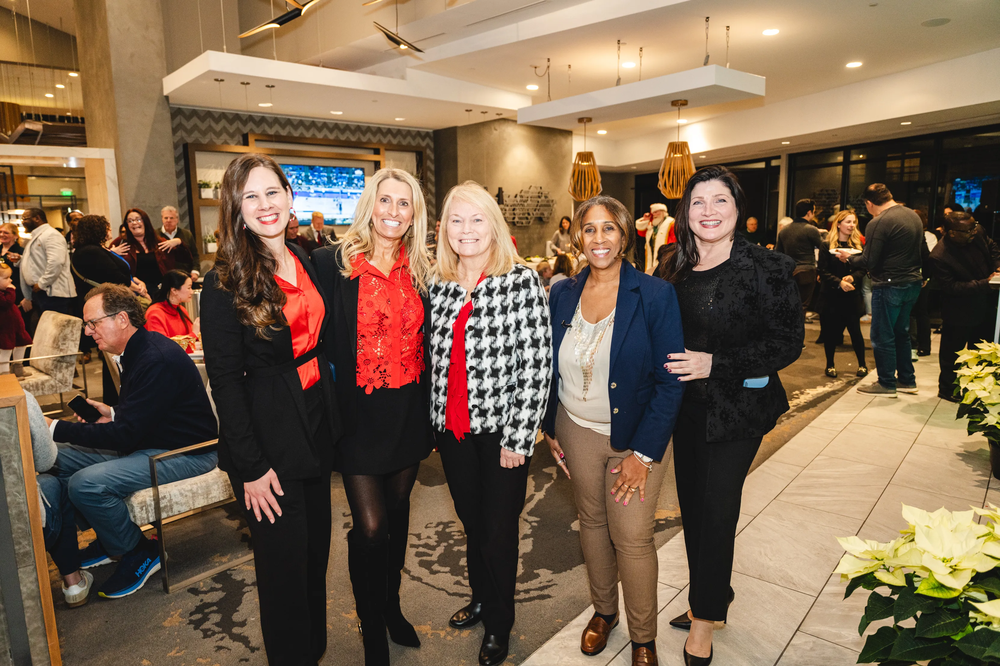A group of women smiling at the Holiday Spirit of Giving event at AVE King of Prussia