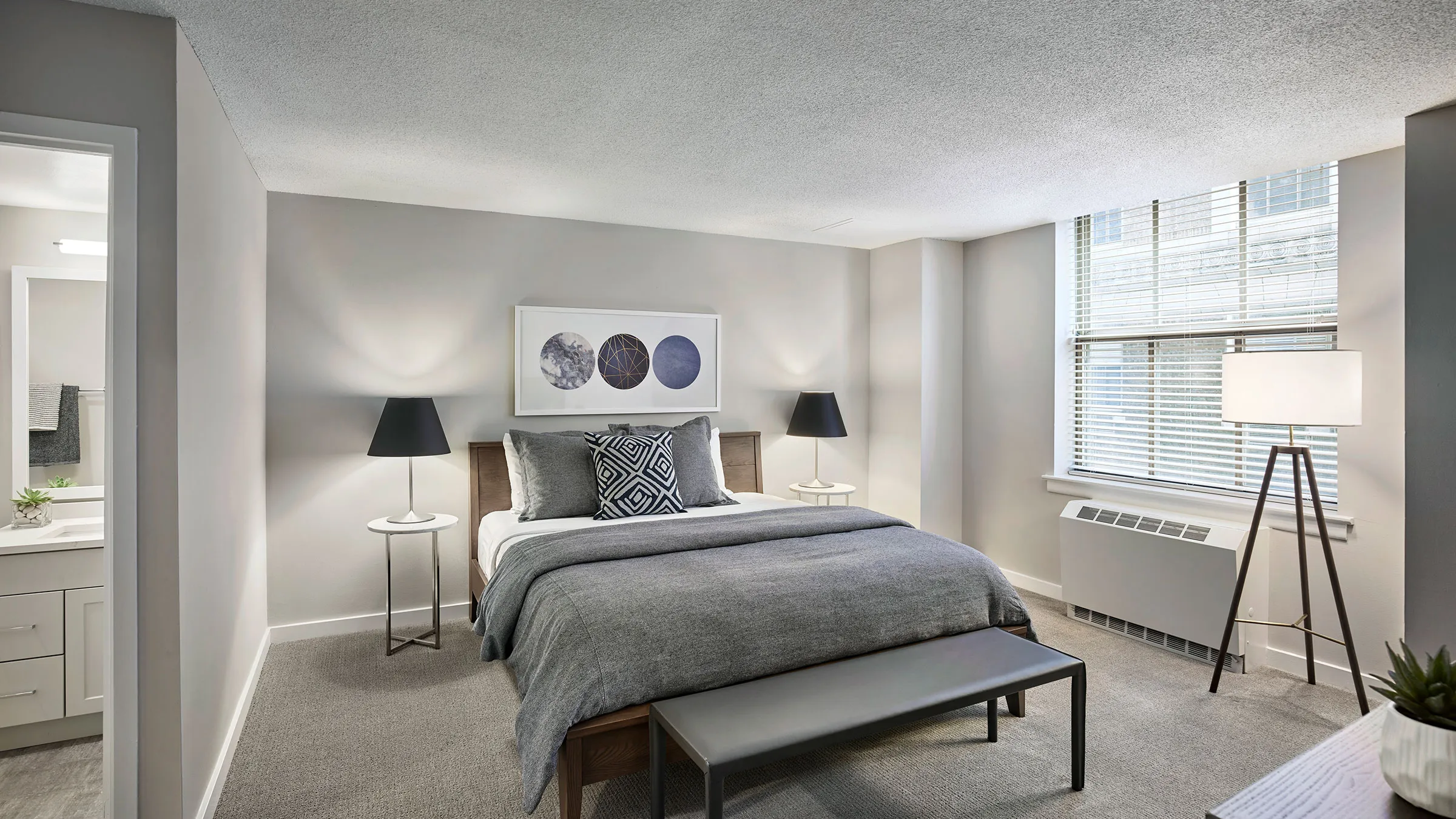 a bedroom with a bed and a bench